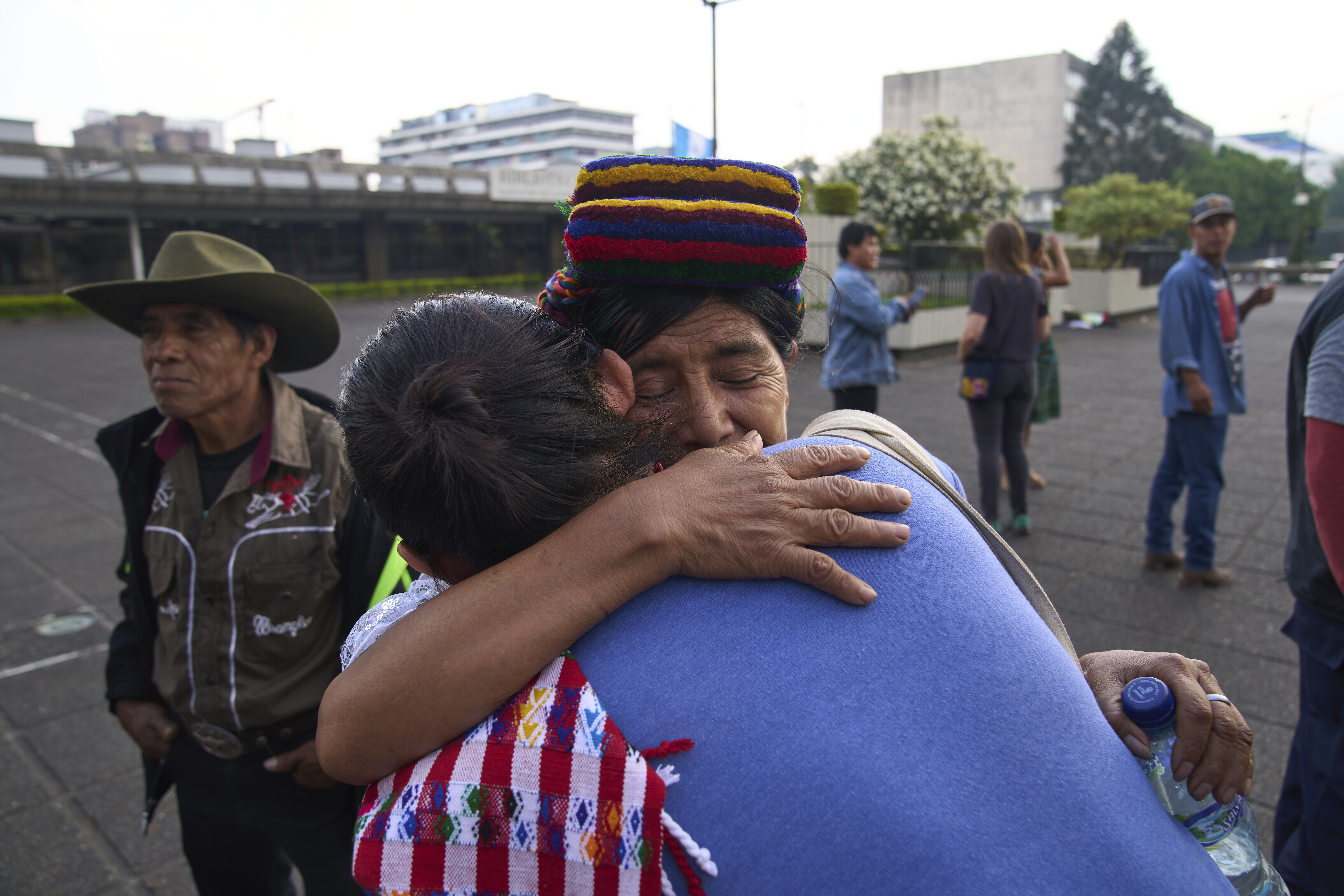 An Indigenous woman is embraced by an activist after a court found three former paramilitary fighters guilty of crimes against humanity, including rape, against women during Guatemala's civil war, in Guatemala City, Friday, May 30, 2025. (AP Photo/Moises Castillo)