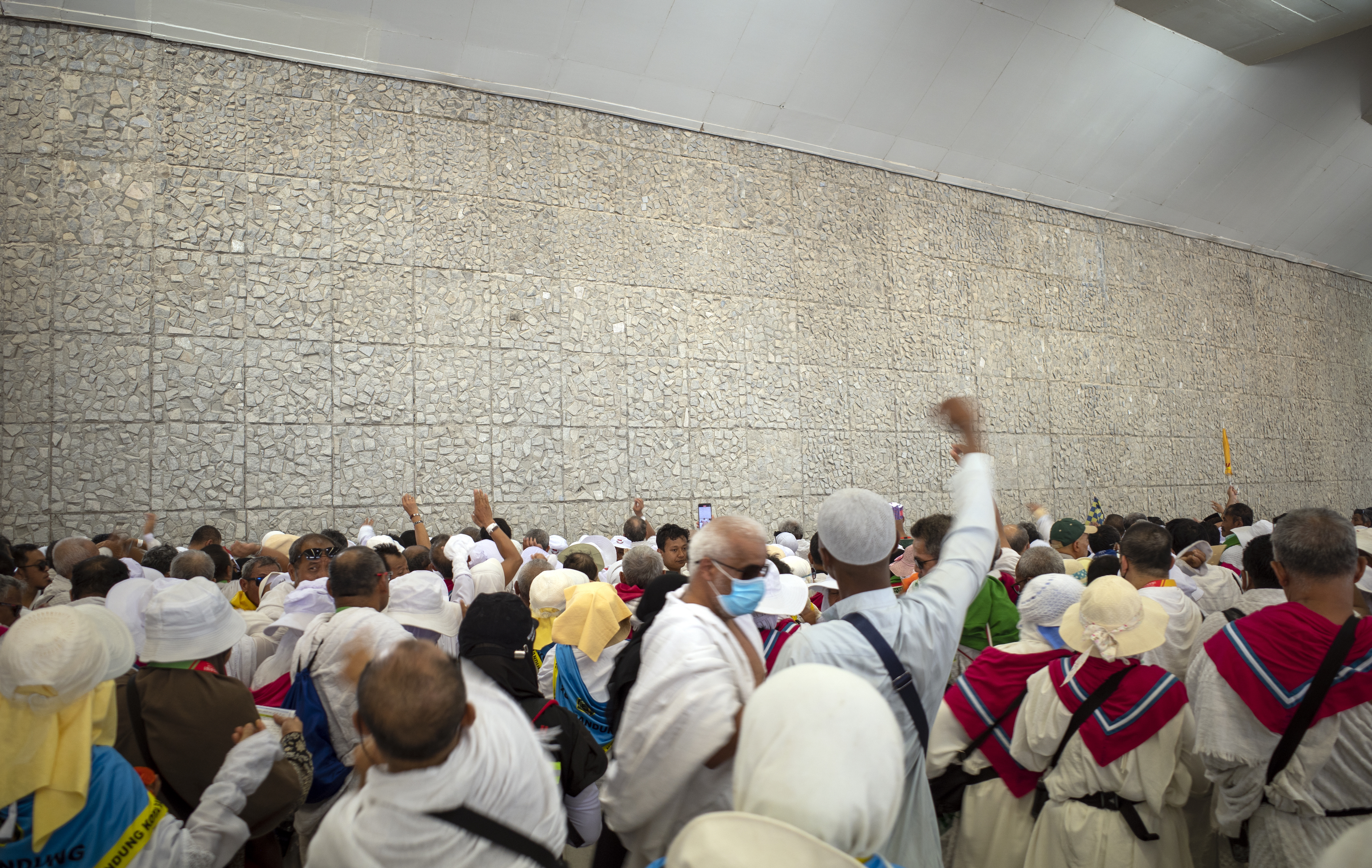 Mecca, Saudi Arabia - June 16, 2024: Pilgrims doing the Jamarat stoning ritual in Mina, Saudi Arabia during in Hajj season.