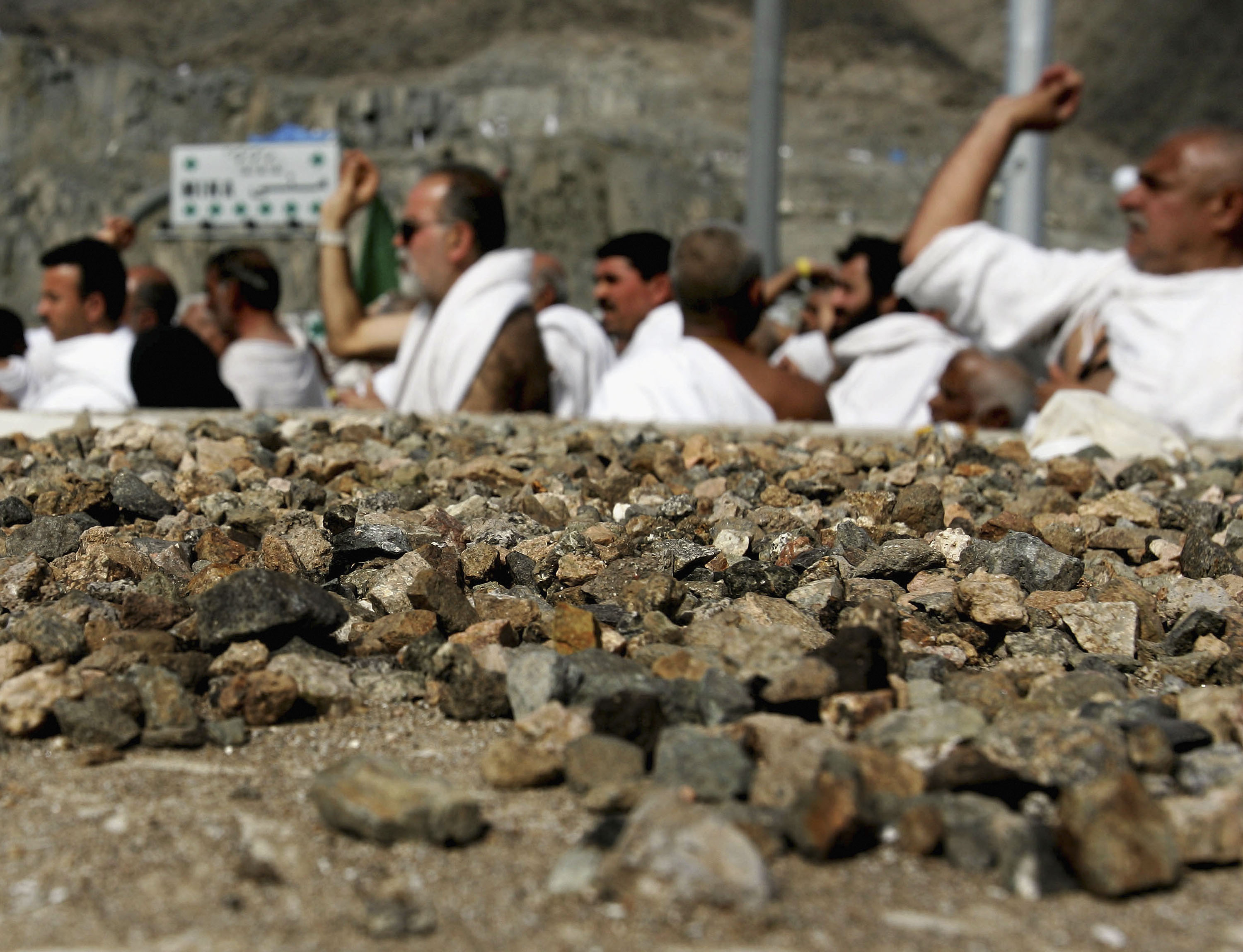 MINA, SAUDI ARABIA JANUARY 20: Muslim Pilgrims throw stones at a pillar representing the devil in Mina outside Mecca, Saudi Arabia on Thursday, Jan. 20, 2005. More than two million pilgrims are headed to Mina to throw stones at its pillars on the second day of the annual hajj pilgrimage which is one of the most sacred duties of the Muslim faith, required at least once for every able bodied Muslim who can afford it . (Photo/ Abid Katib/Getty Images)