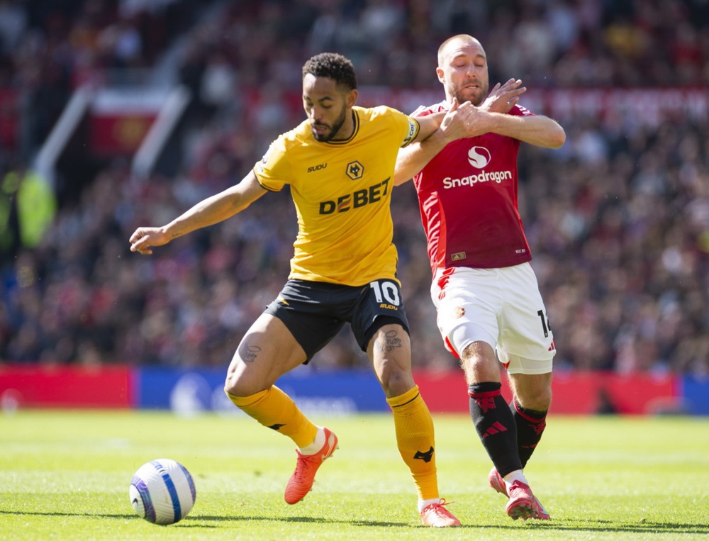 Matheus Cunha of Wolverhampton Wanderers in action with Christian Eriksen of Manchester United during the English Premier League