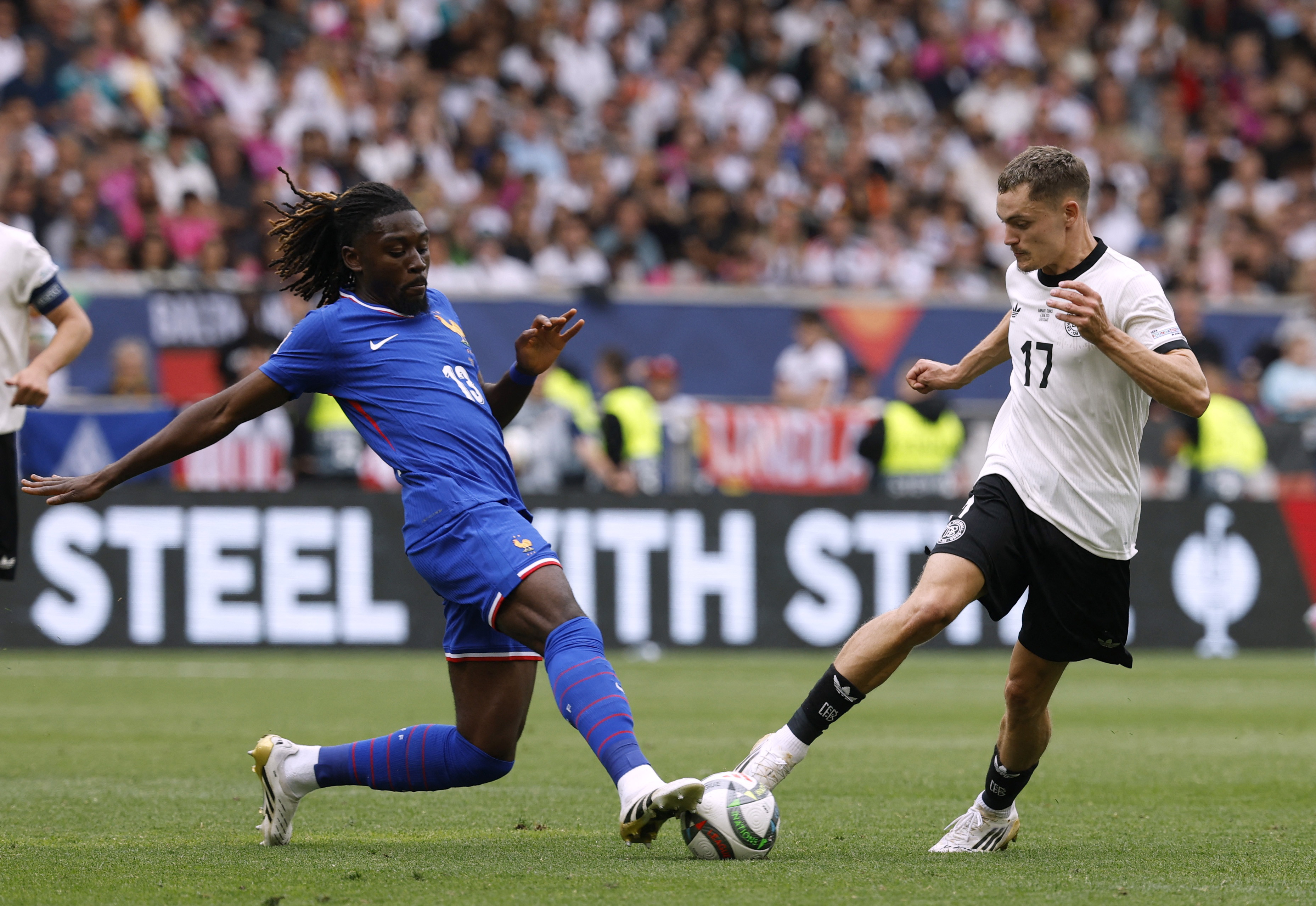 France's Manu Kone in action with Germany's Florian Wirtz