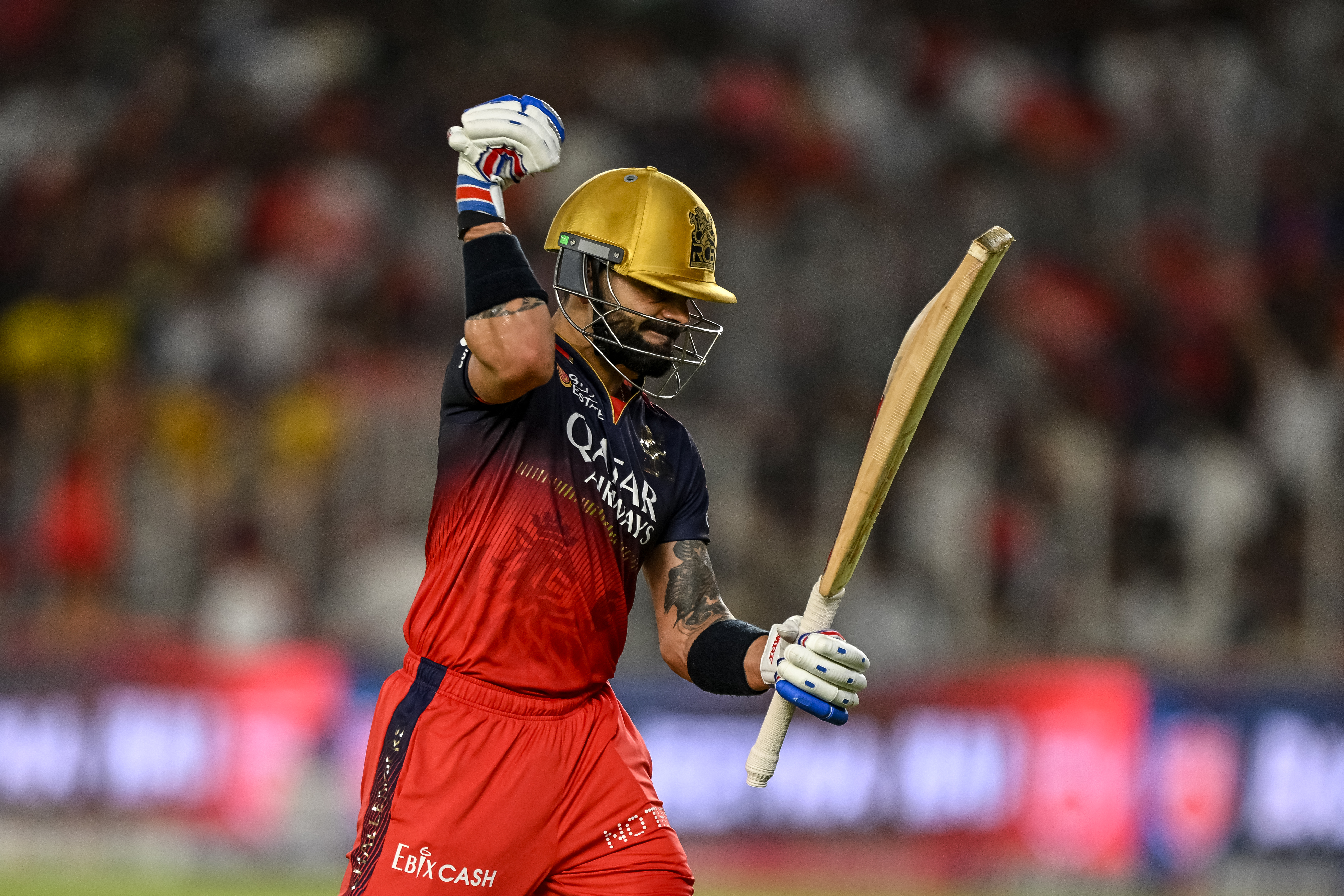 Royal Challengers Bengaluru's Virat Kohli reacts as he walks back to the pavilion after his dismissal during the Indian Premier League (IPL) Twenty20 final cricket match between Royal Challengers Bengaluru and Punjab Kings at the Narendra Modi Stadium in Ahmedabad