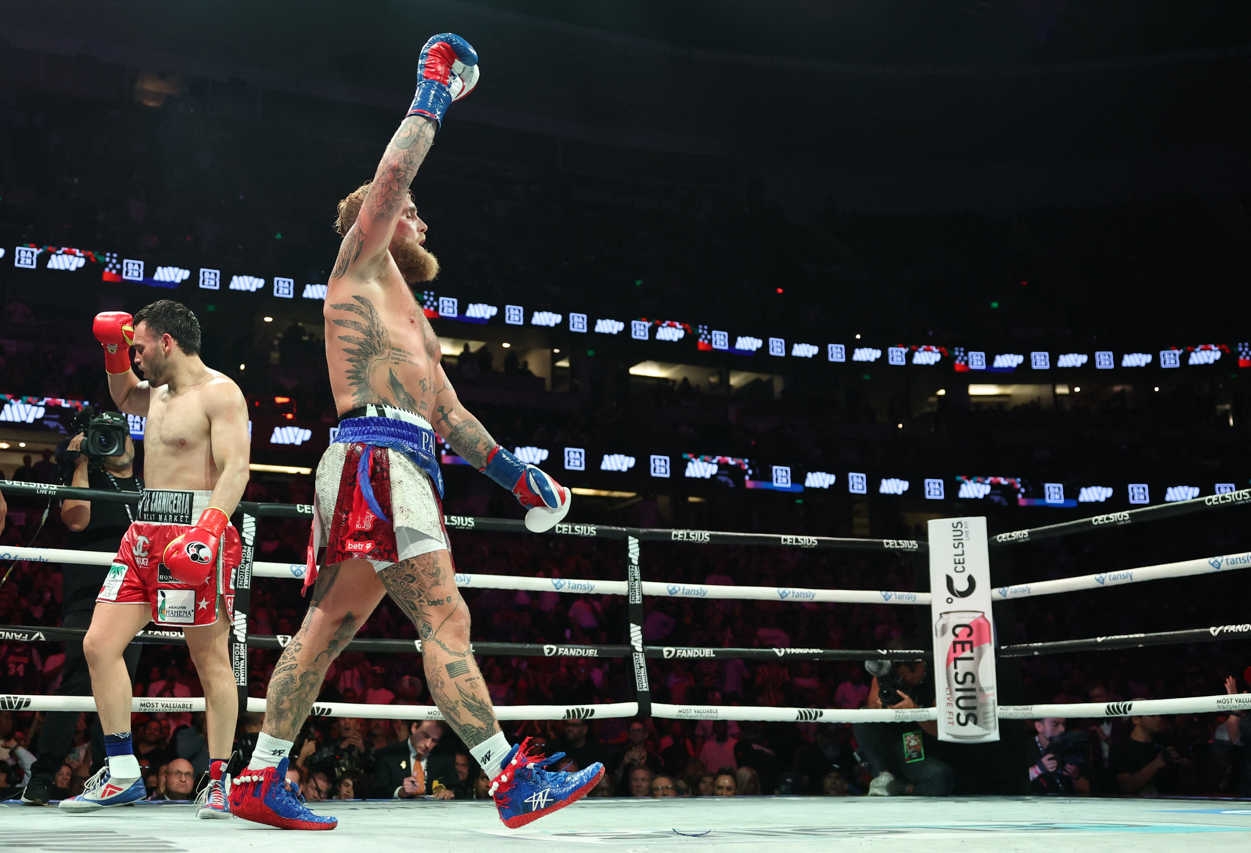 USA's Jake Paul celebrates winning the cruiserweight boxing bout against Mexico's Julio Cesar Chavez Jr. (L) at the Honda Center in Anaheim, California, on June 28, 2025. (Photo by Patrick T. Fallon / AFP)