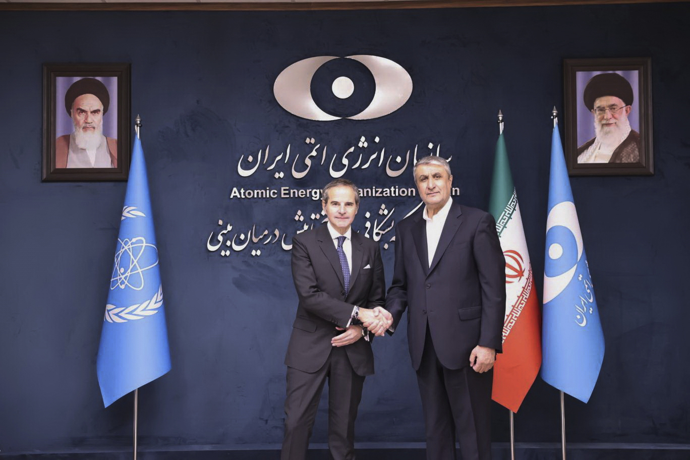 In this photo released by the Atomic Energy Organisation of Iran, International Atomic Energy Agency (IAEA) Director General, Rafael Mariano Grossi, left, shakes hands with head of the Atomic Energy Organization of Iran Mohammad Eslami, at the Atomic Energy Organisation of Iran, in Tehran, Iran, Thursday, April 17, 2025. (Atomic Energy Organisation of Iran via AP)