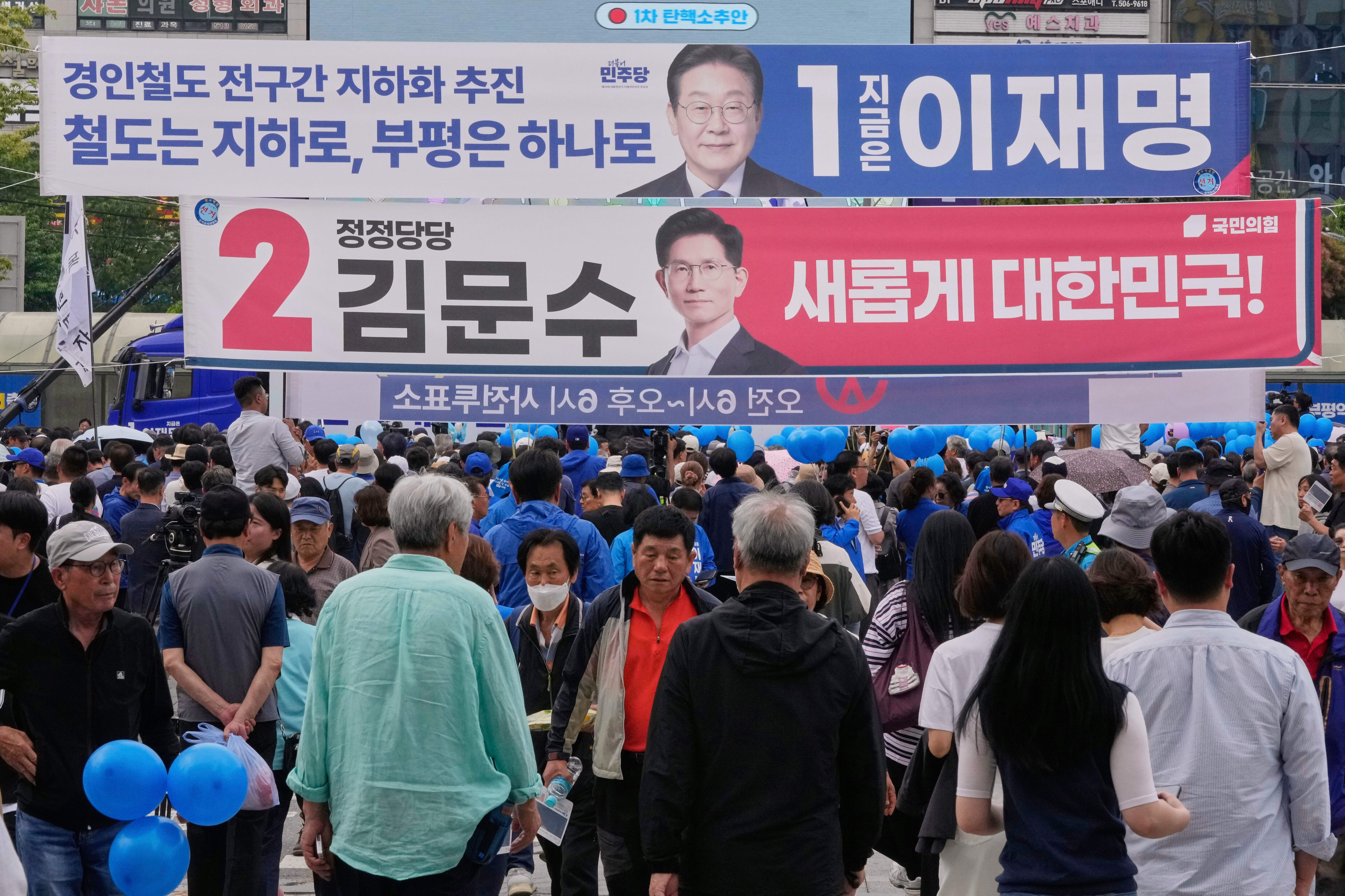 Banners featuring South Korea's Democratic Party's presidential election candidate Lee Jae-myung, top, and People Power Party's presidential candidate Kim Moon Soo hang at a street in Incheon, South Korea, Wednesday, May 21, 2025. (AP Photo/Ahn Young-joon)