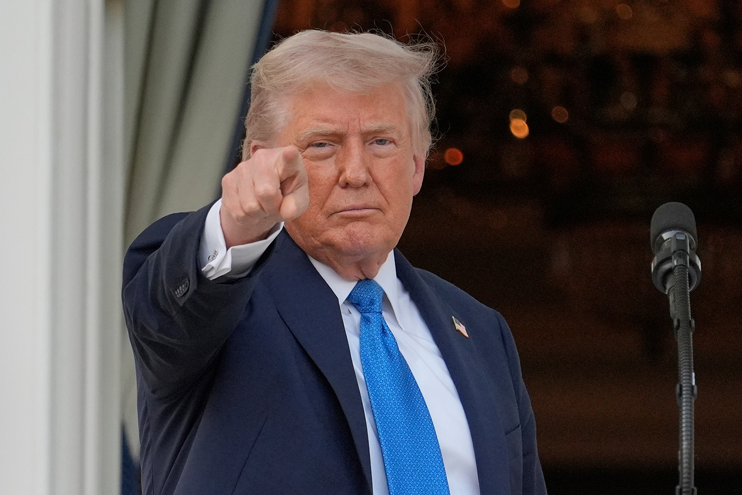 President Donald Trump gestures after speaking during a summer soiree
