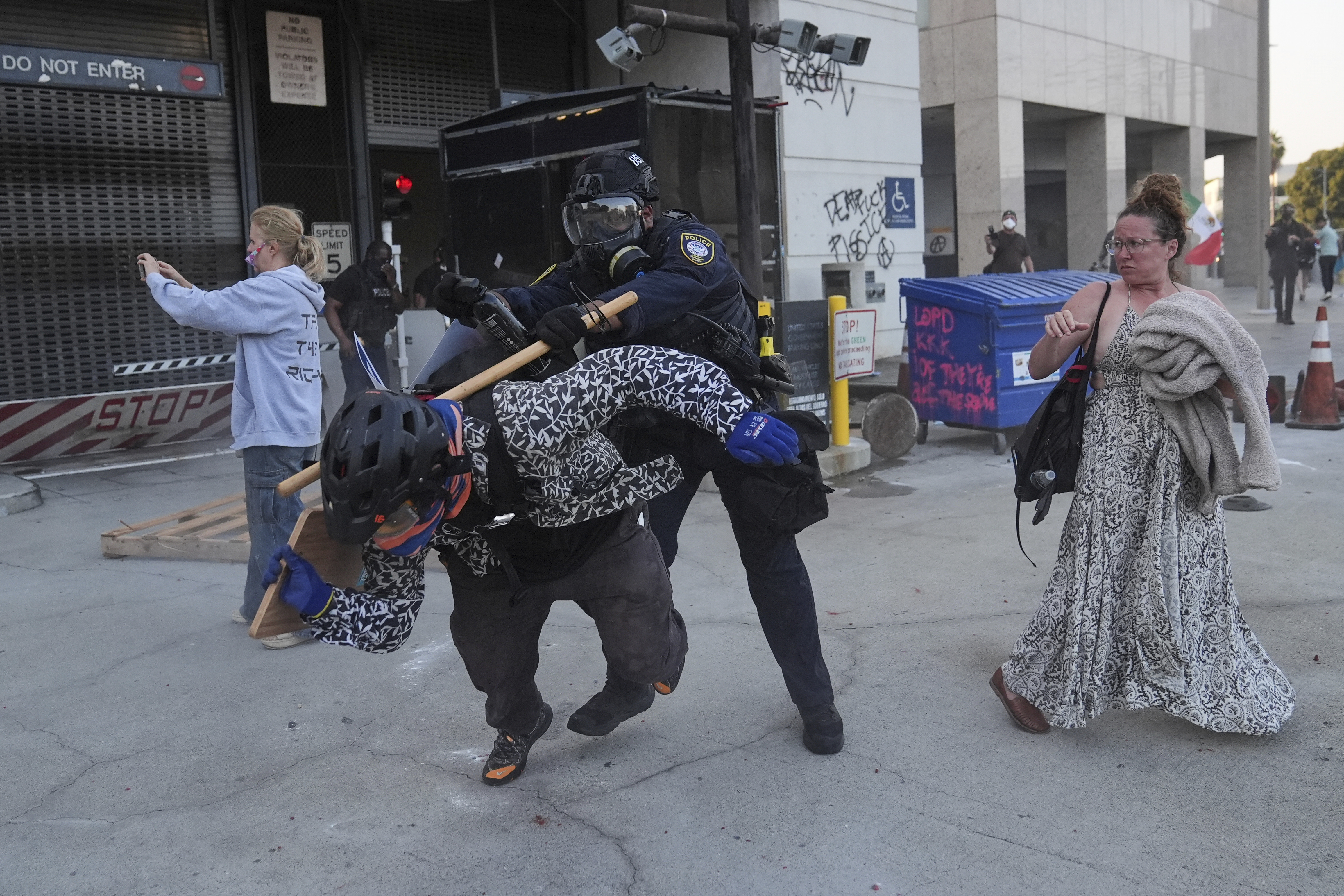 A protester attempts to evade a Department of Homeland Security officer.