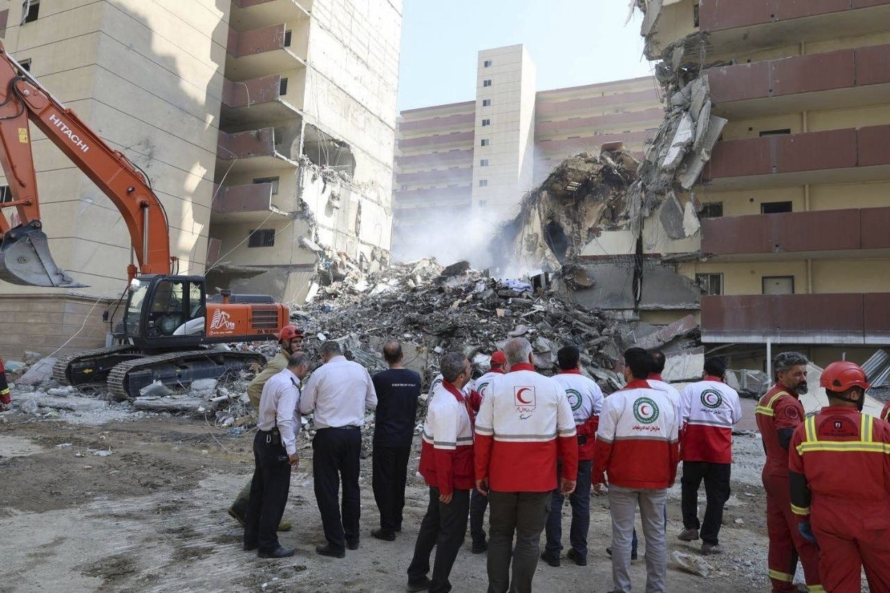 In this photo released by the Iranian Red Crescent Society rescuers work at the scene of an explosion after an Israeli strike in Tehran, Iran, Friday, June 13, 2025. (Iranian Red Crescent Society via AP)
