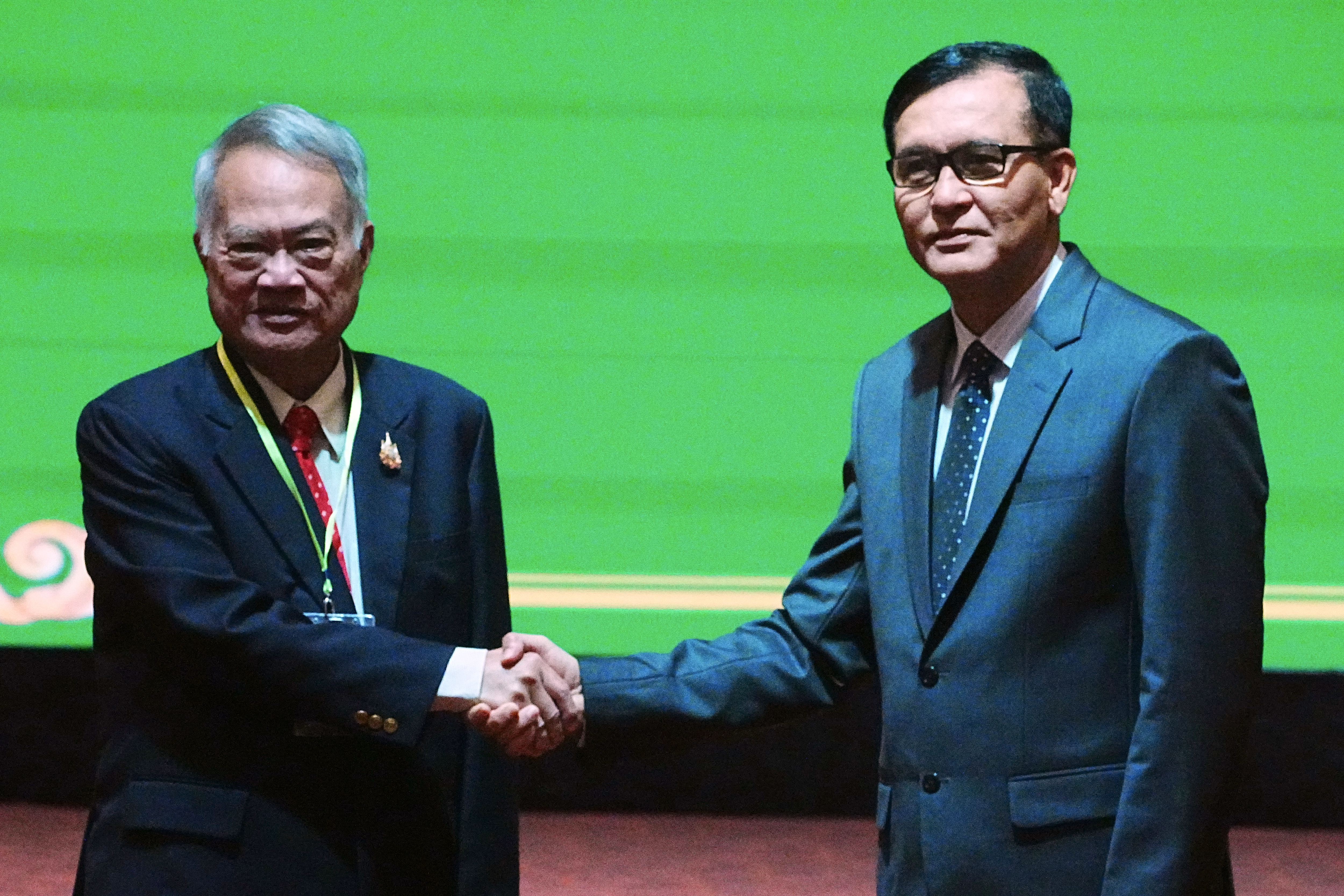Cambodian Minister in charge of State Secretariat of Border Affairs Lam Chea, right, shakes hands with Thai Border Affairs Advisor to the Ministry of Foreign Affairs Prasas Prasasvinitchai, left, during a meeting of the Cambodian-Thai joint commission on the demarcation for the land boundary in Phnom Penh, Cambodia on June 14, 2025.