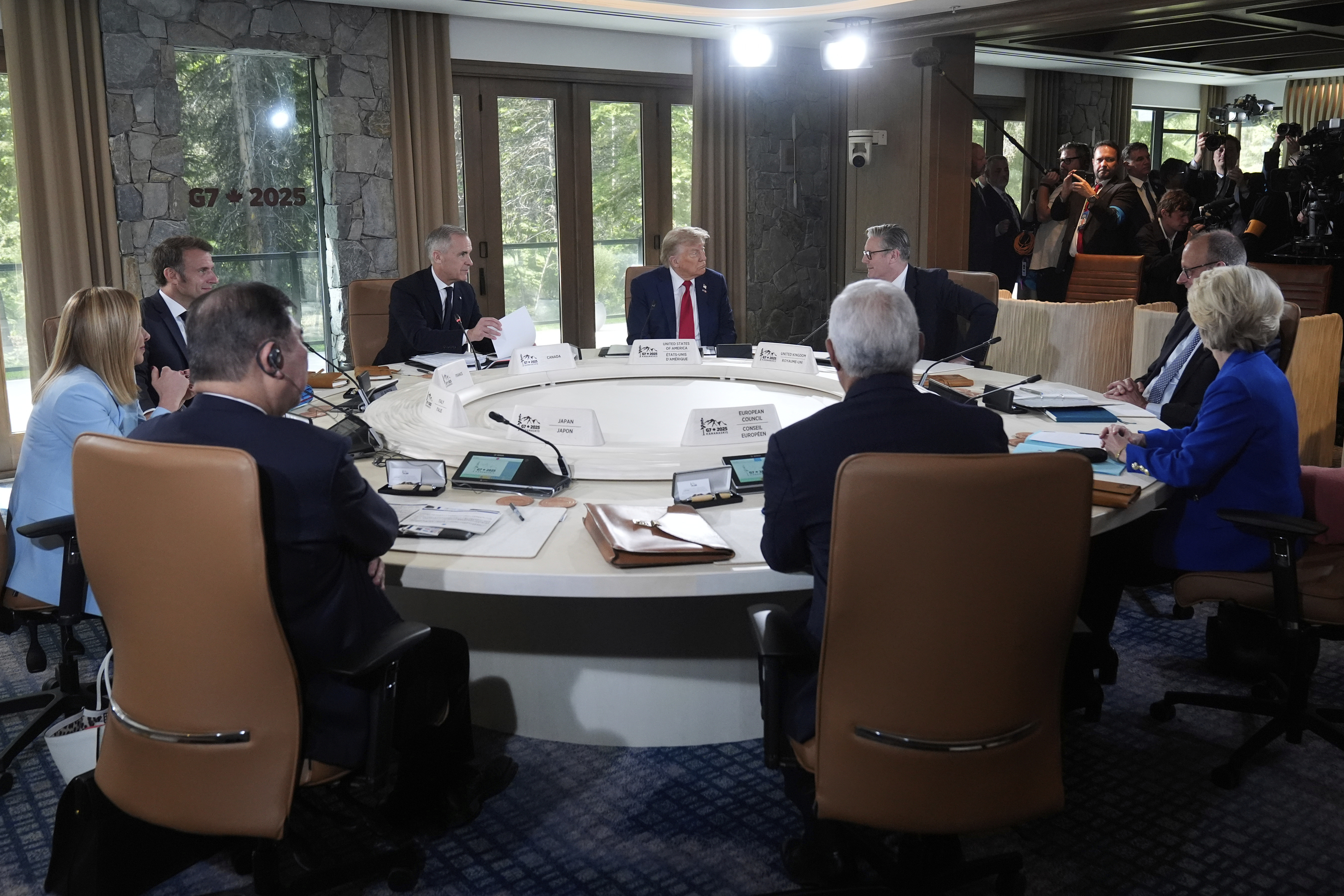 Italy's Prime Minister Giorgia Meloni, from left, France's President Emmanuel Macron, Canada's Prime Minister Mark Carney, President Donald Trump, Britain's Prime Minister Keir Starmer and Germany's Chancellor Friedrich Merz participate in a session of the G7 Summit, Monday, June 16, 2025, in Kananaskis, Canada. (AP Photo/Mark Schiefelbein