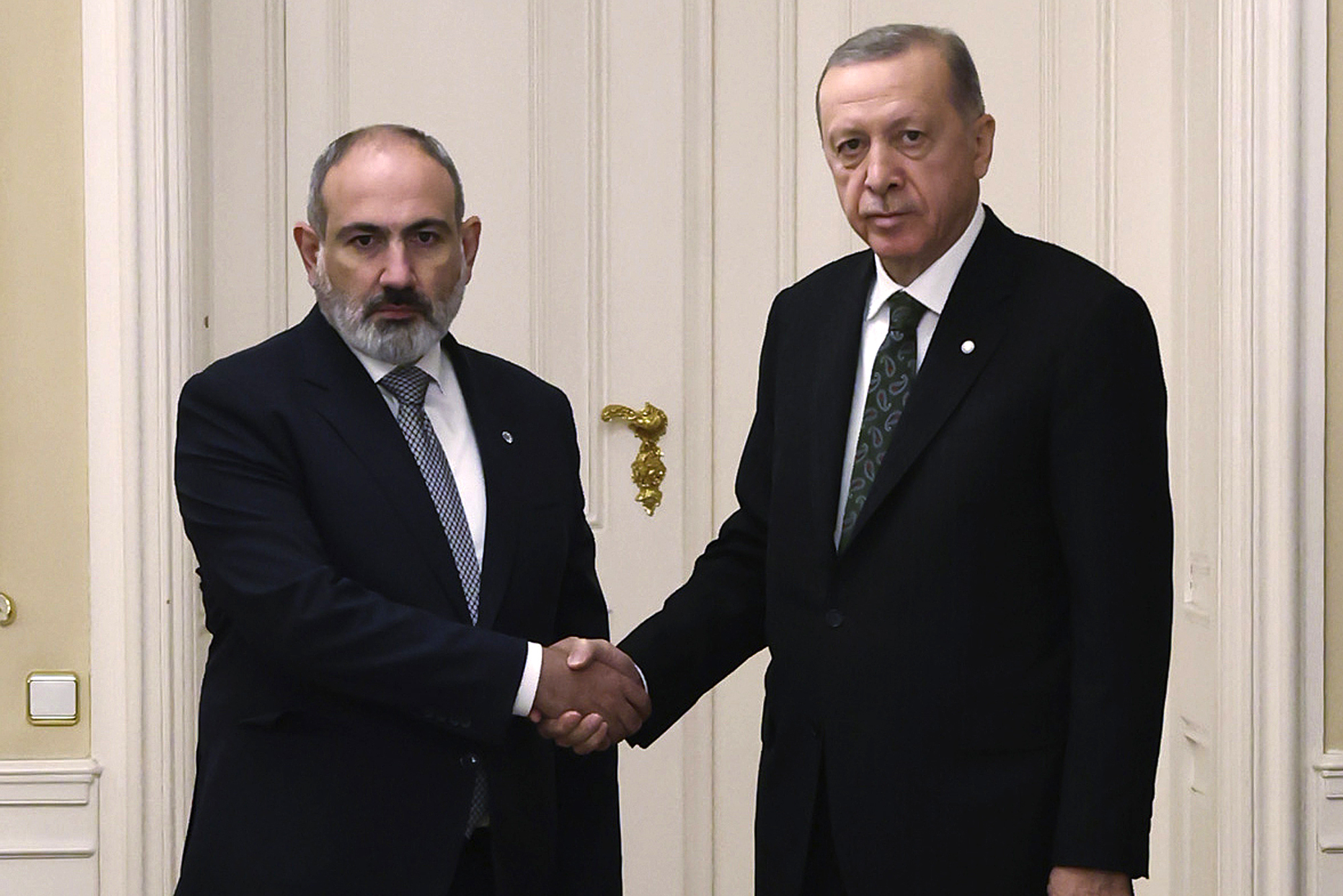 Turkey's President Recep Tayyip Erdogan, right, and Armenia's Prime Minister Nikol Pashinyan shake hands before a meeting at Prague Castle in Prague, Czech Republic on October 6, 2022.