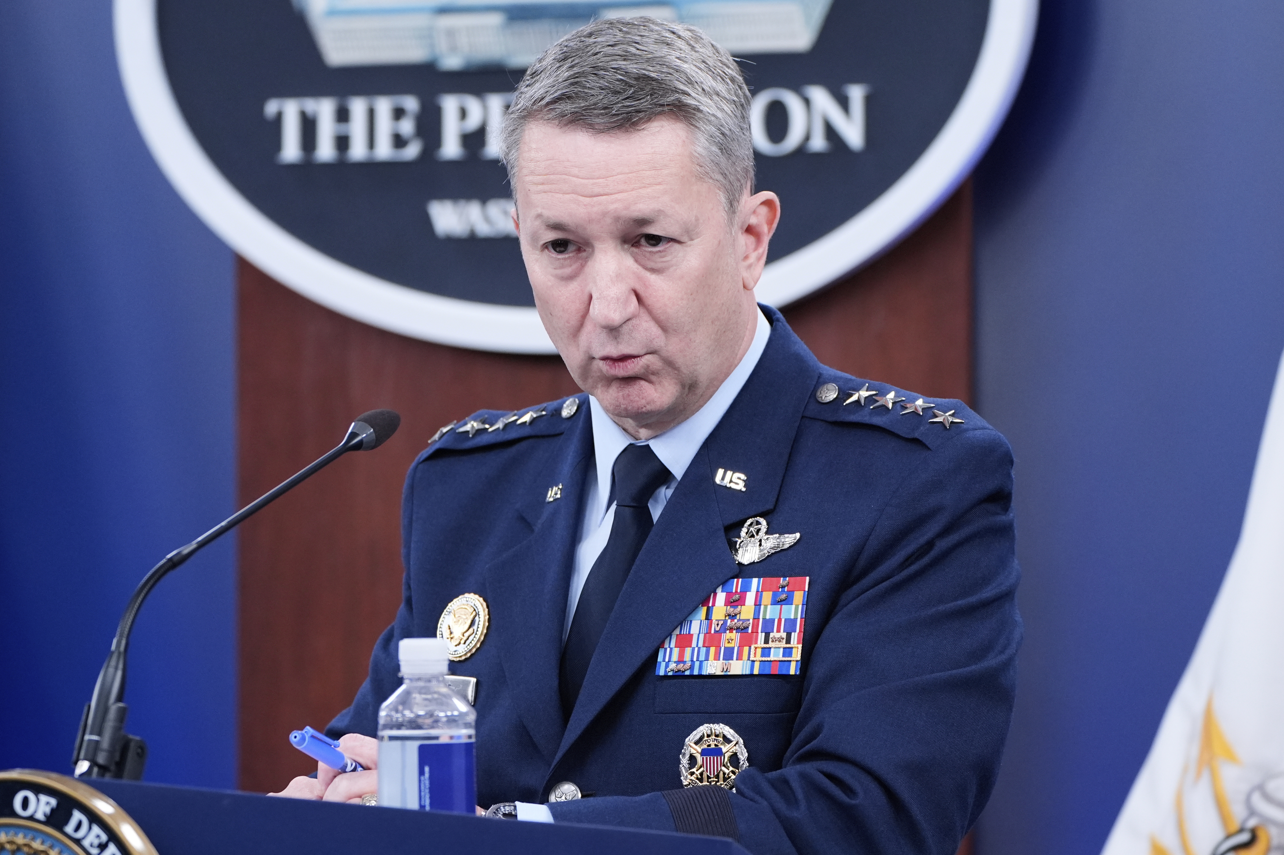 Dan Caine speaks at a podium during a news conference at the Pentagon.
