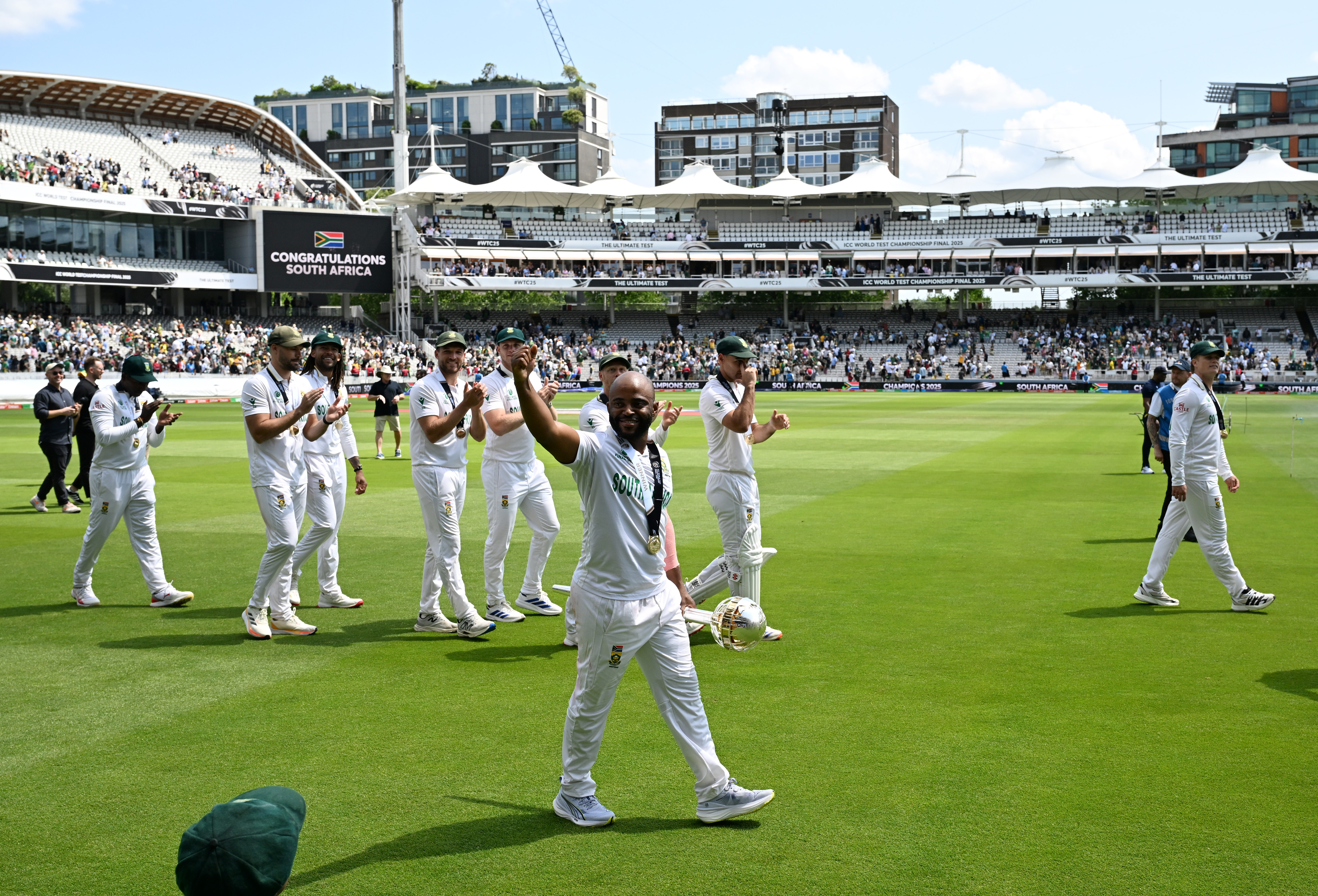 Temba Bavuma of South Africa celebrates to the fans as he walks around the pitch with his team following victory on Day Four of the ICC World Test Championship Final between South Africa and Australia