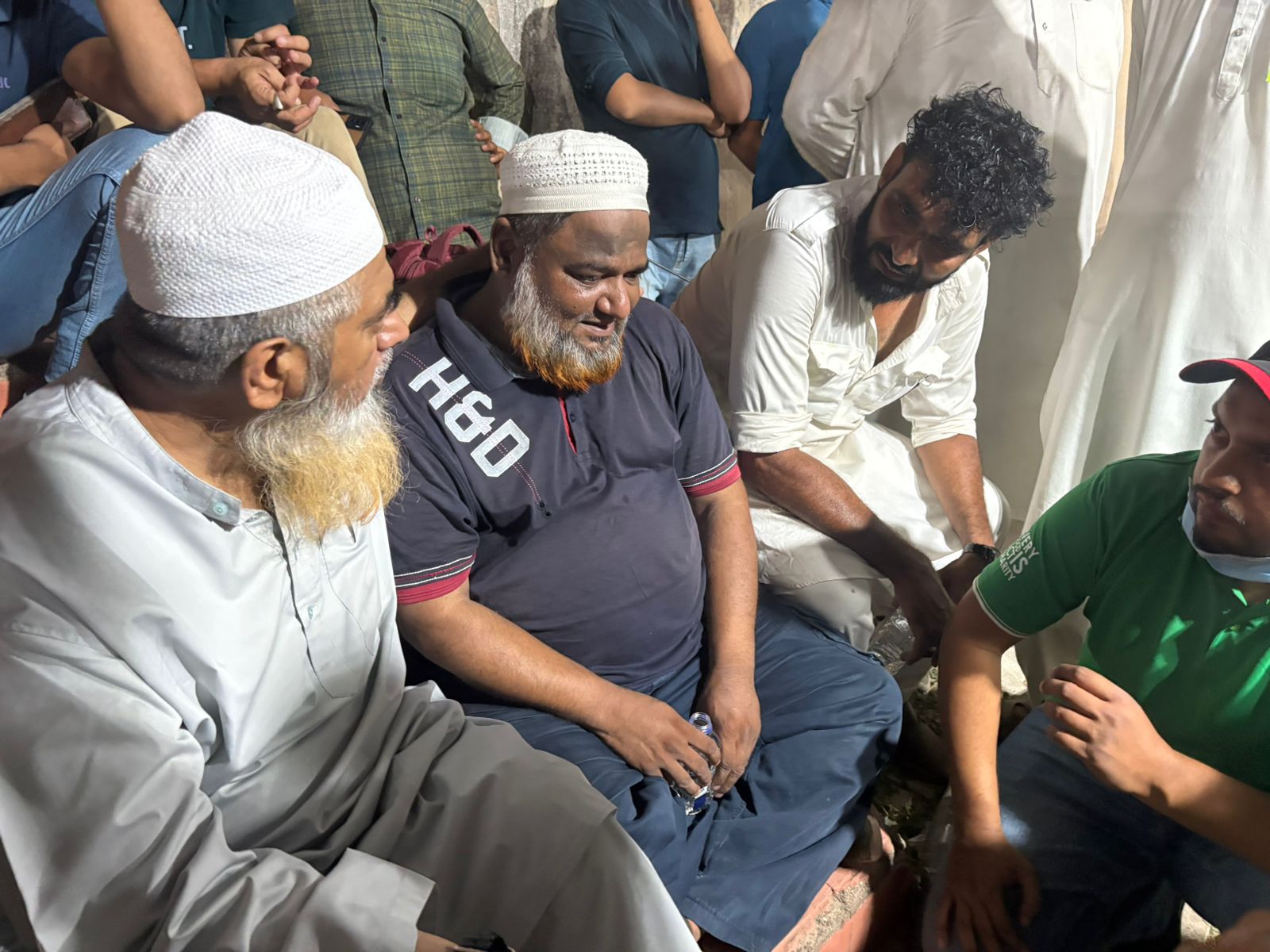 The father (in the blue shirt) of Irfan, one of the flight crew killed when the Air India plane crashed, at the hospital [ Marhaba Halili/Al Jazeera]