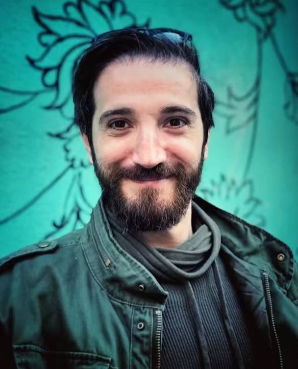 Ehsan Bayrami, a smiling, young bearded man with sunglasses