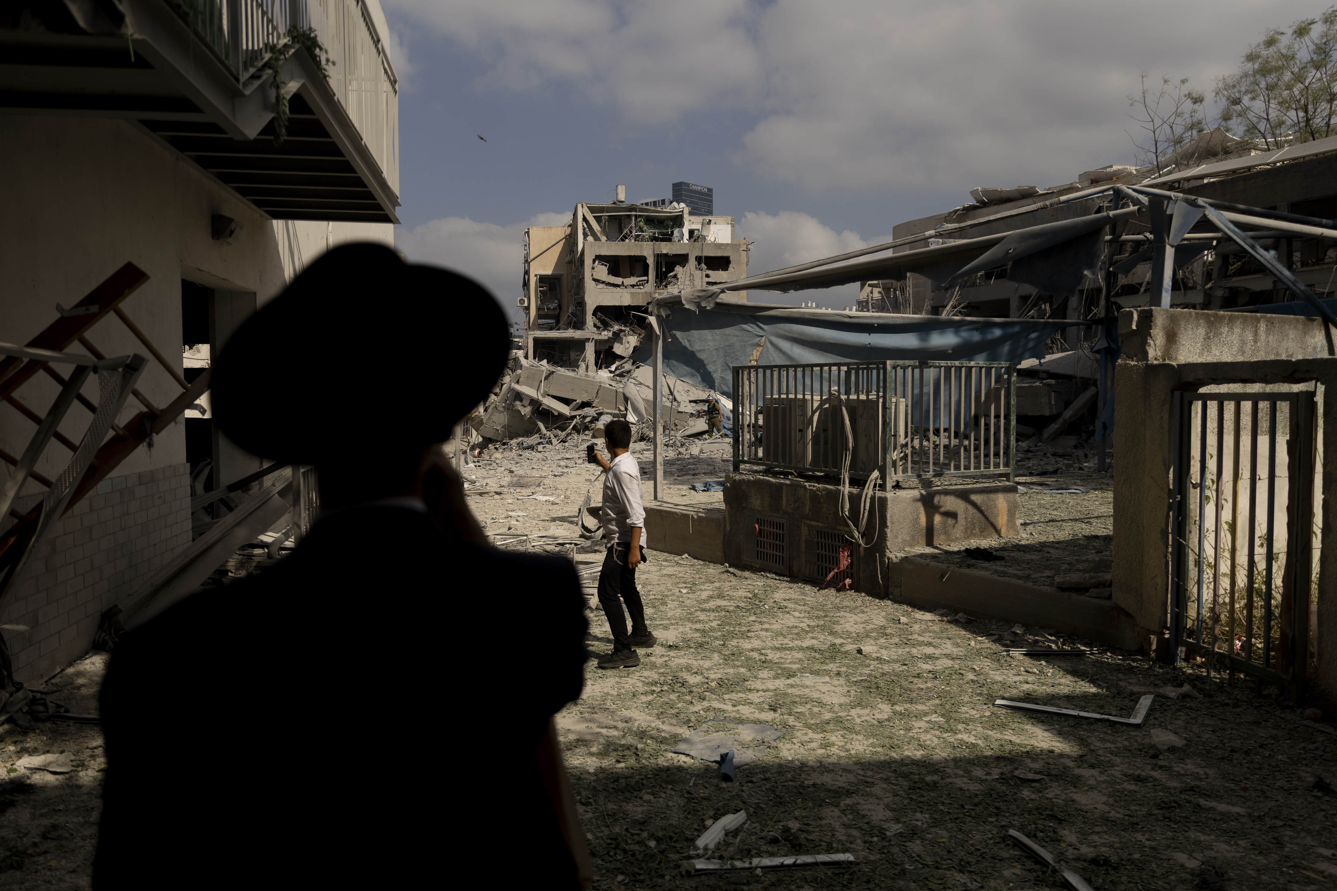 BNEI BRAK, ISRAEL - JUNE 16: Ultra-Orthodox Jewish men look at a scene of a heavily damaged building after an overnight Iranian missile strike on June 16, 2025 in Bnei Brak, Israel. Iran launched a retaliatory missile strike on Israel starting late on June 13, after a series of Israeli airstrikes earlier in the day targeted Iranian military and nuclear sites, as well as top military officials. (Photo by Amir Levy/Getty Images)