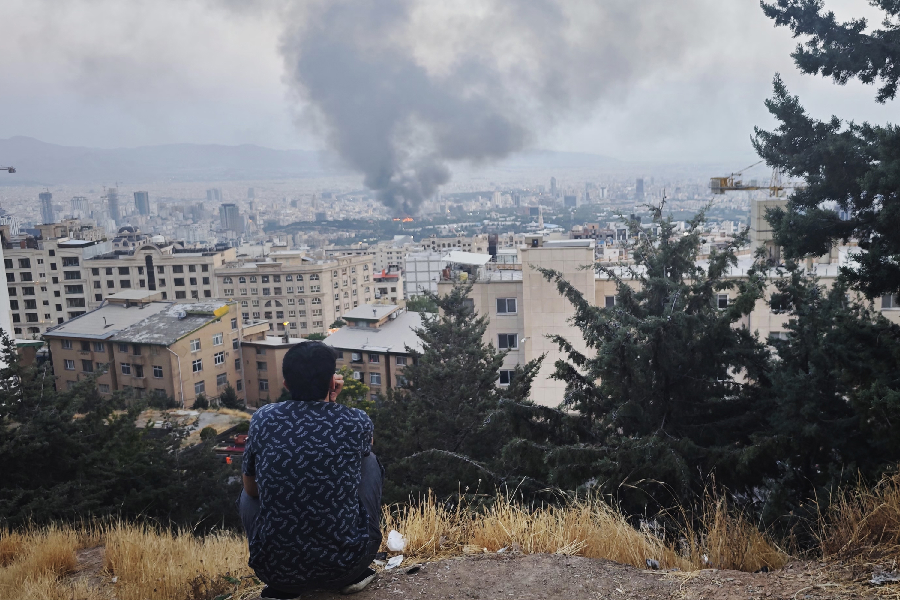 TEHRAN, IRAN - JUNE 16: Smoke rises after a reported Israeli strike on a building used by Islamic Republic of Iran News Network, part of Iran's state TV broadcaster, on June 16, 2025 in Tehran, Iran. Over recent days, Iran has been hit by a series of Israeli airstrikes targeting military and nuclear sites, as well as top military officials, prompting Iran to launch a counterattack. (Photo by Stringer/Getty Images)