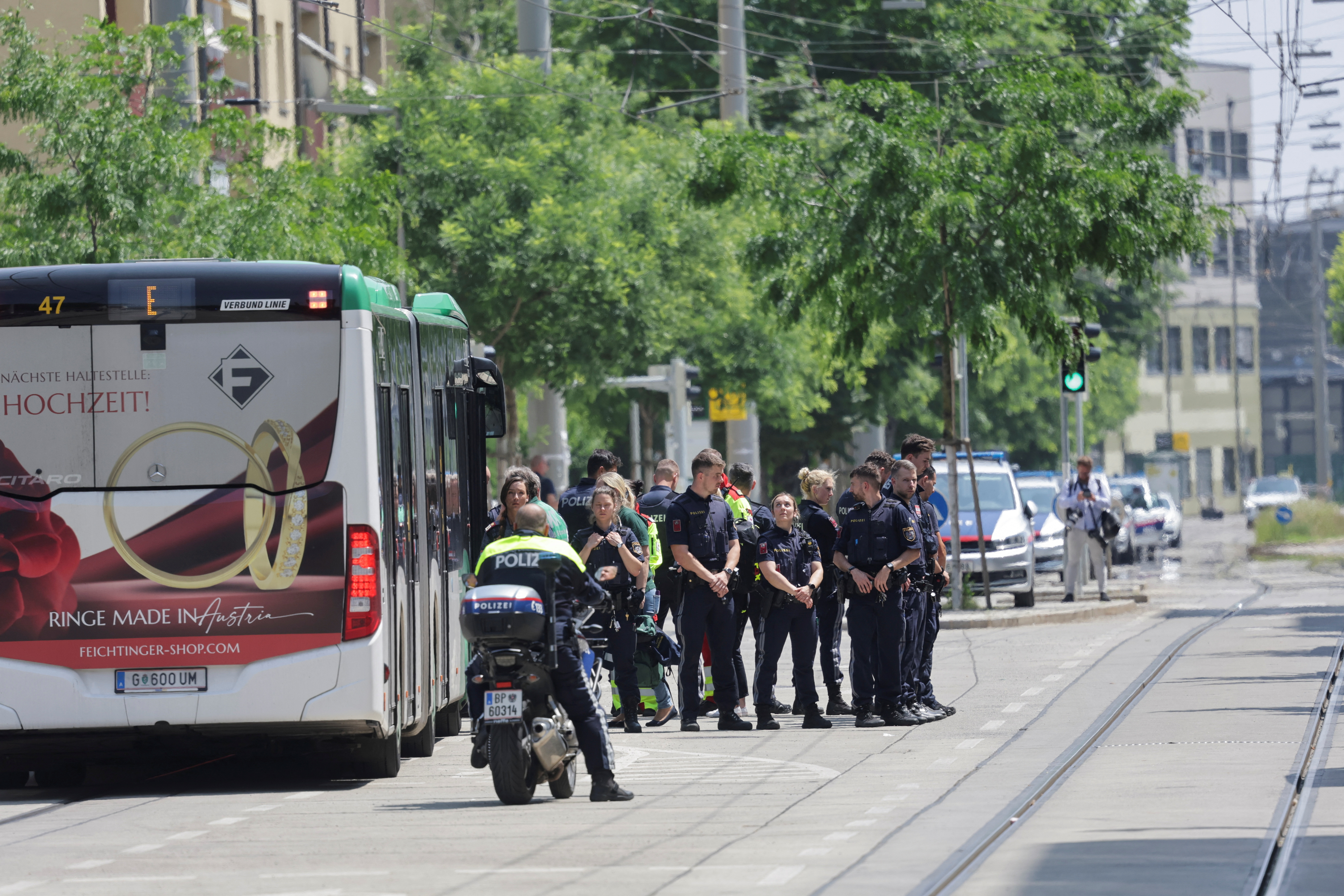 Police officers stand guard near a school following a deadly school shooting in Graz, Austria, June 10, 2025. REUTERS/Leonhard Foeger