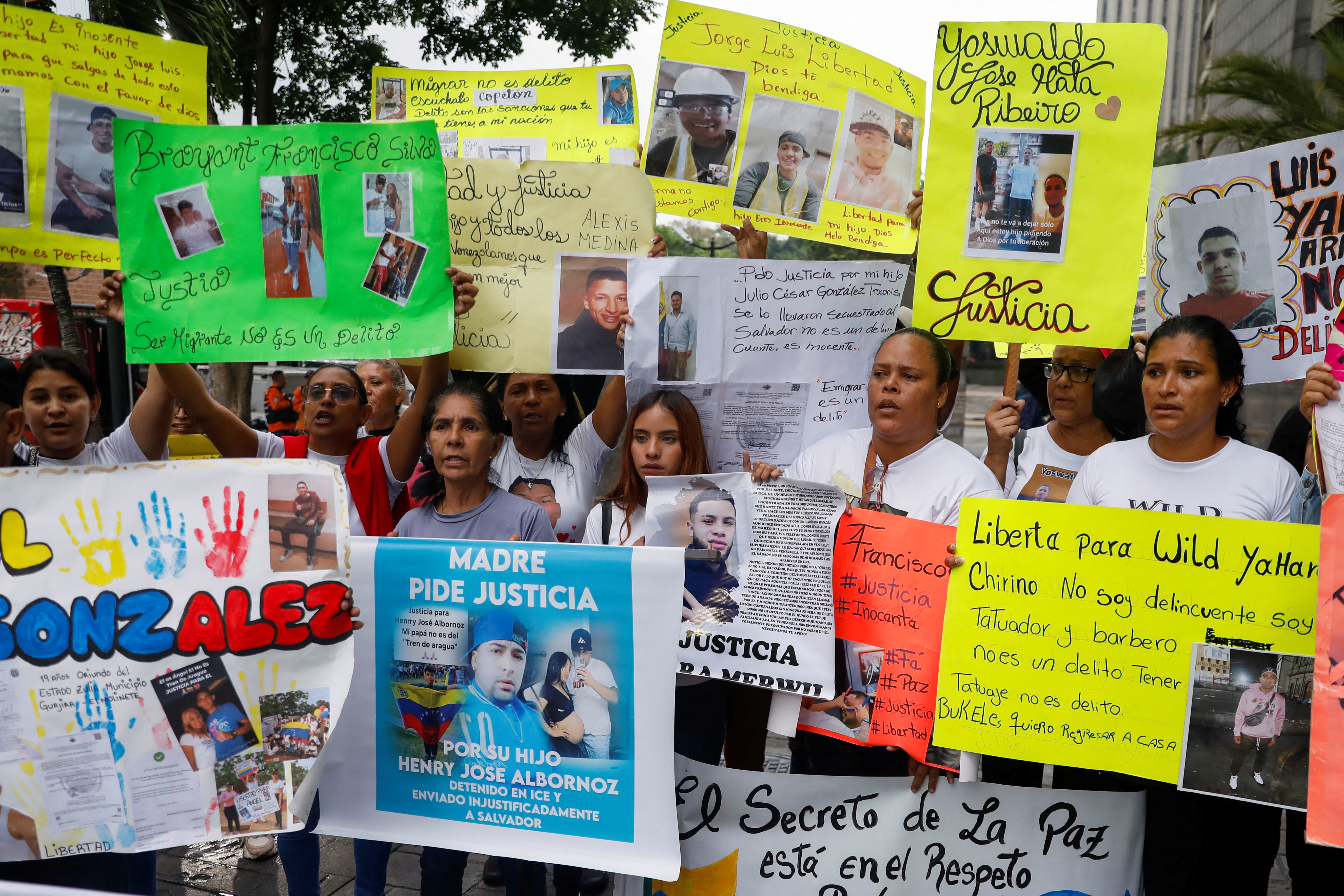 Protesters hold up images of family members imprisoned in El Salvador outside the UN building in Caracas.