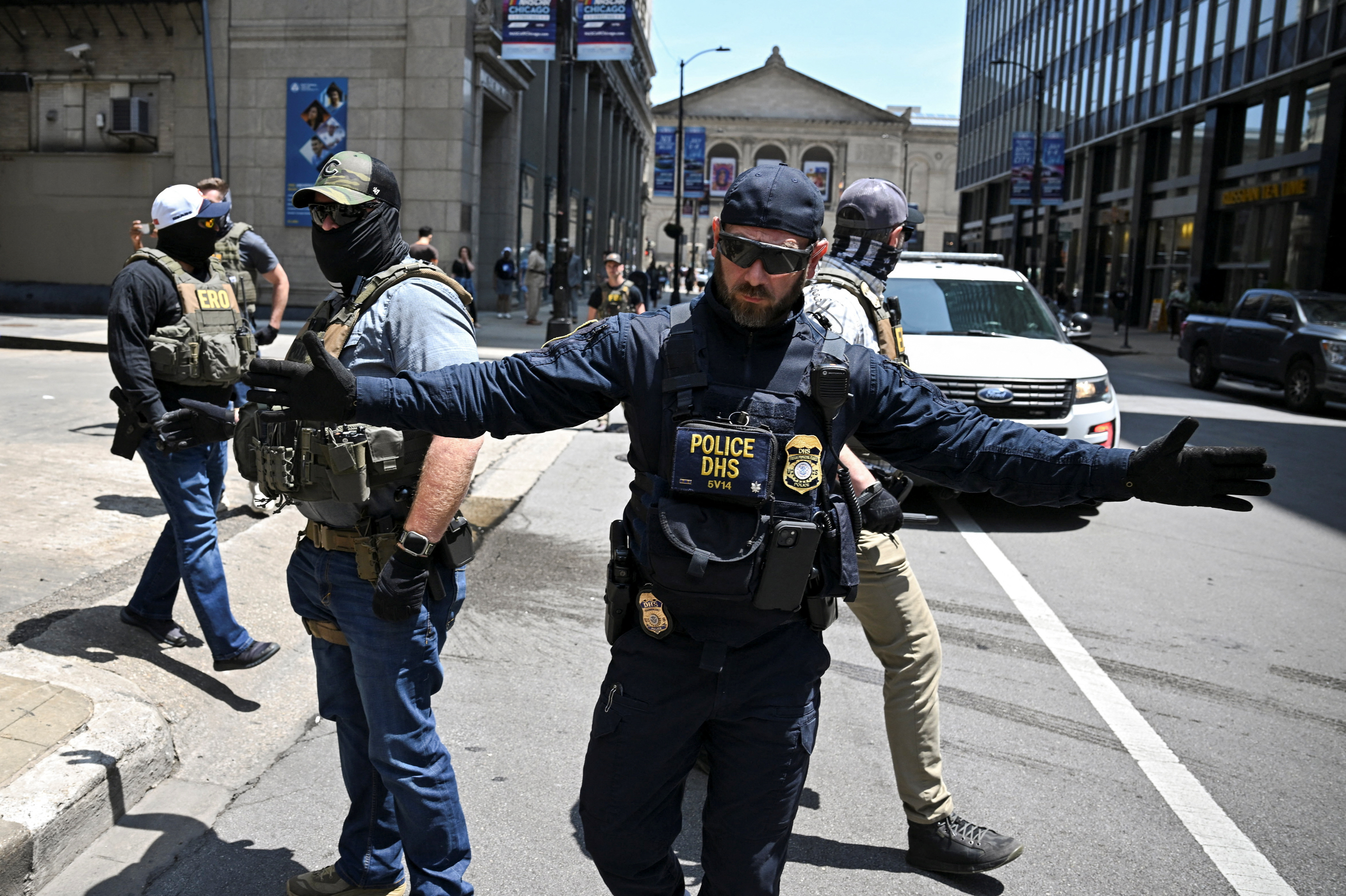 Law enforcement officers stand guard as protesters attempt to block US Immigration and Customs Enforcement