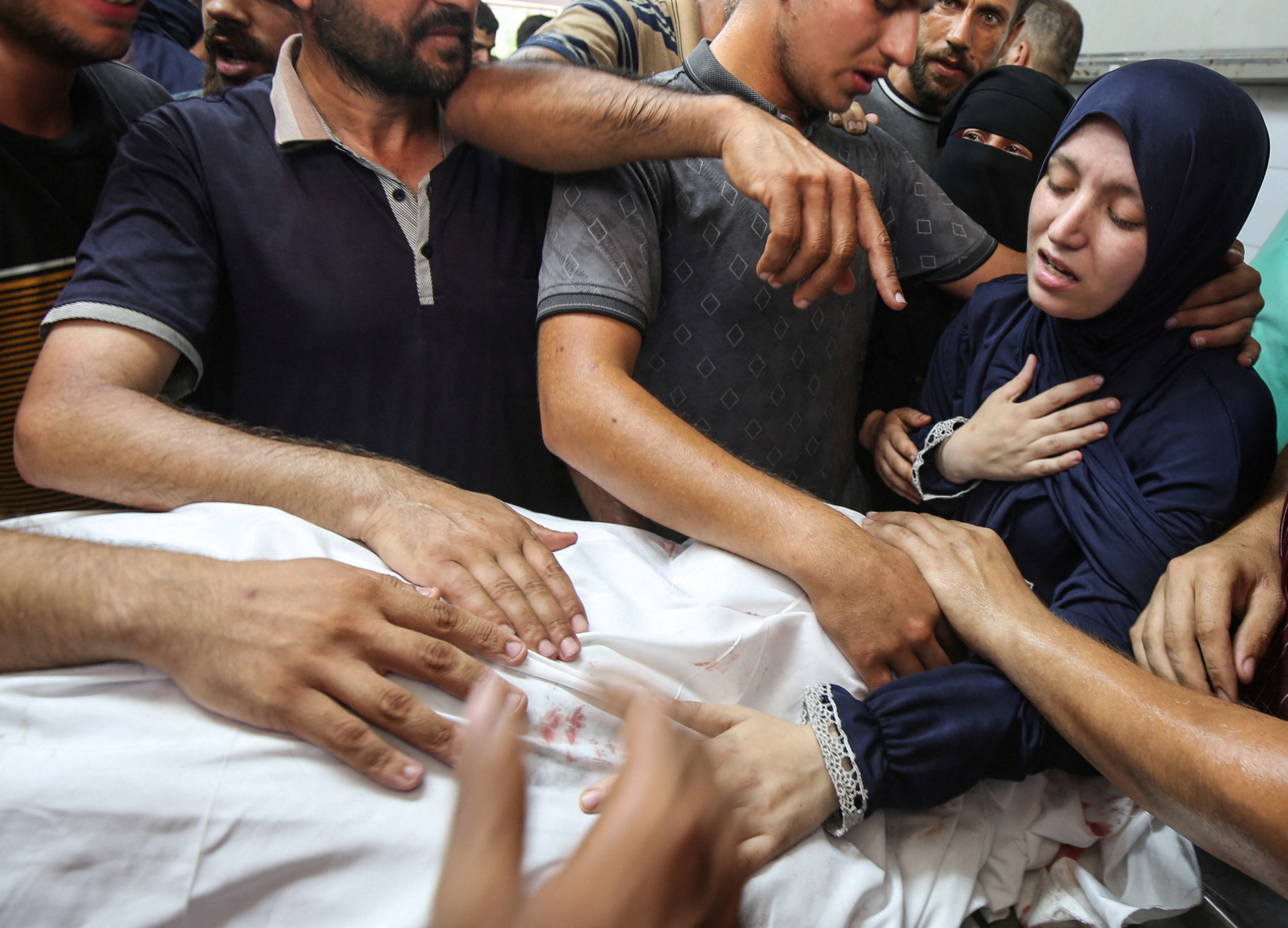 Palestinians react over bodies as they mourn doctor Marwan al-Sultan, director of the Indonesian Hospital in northern Gaza Strip, his wife, his daughter and and his sister, who were killed in an Israeli strike on Wednesday, according to Gaza’s health ministry, at Al-Shifa hospital in Gaza City, July 2, 2025. REUTERS/Mahmoud Issa