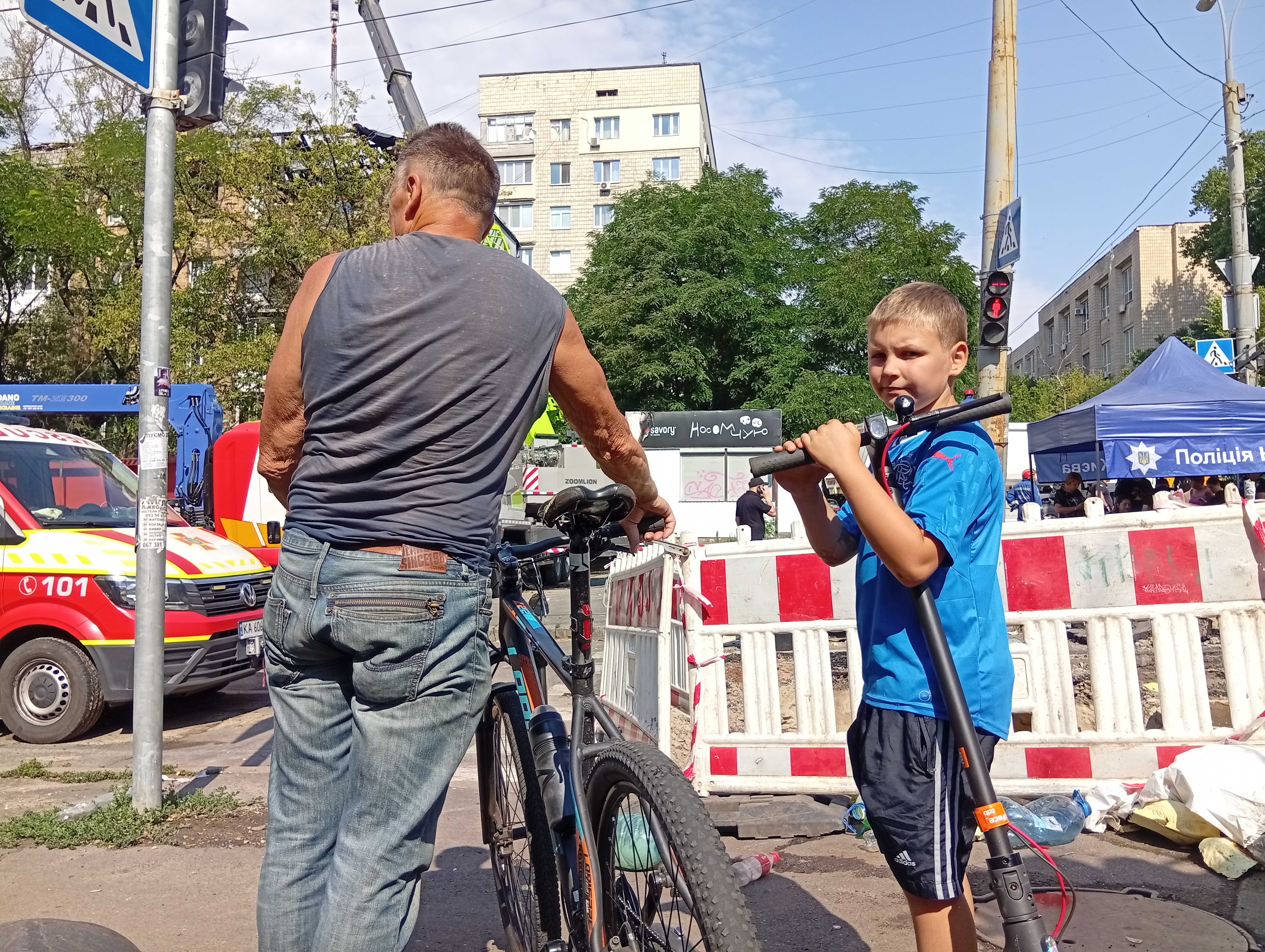 A boy trying to return to their damaged apartment block-1752486279