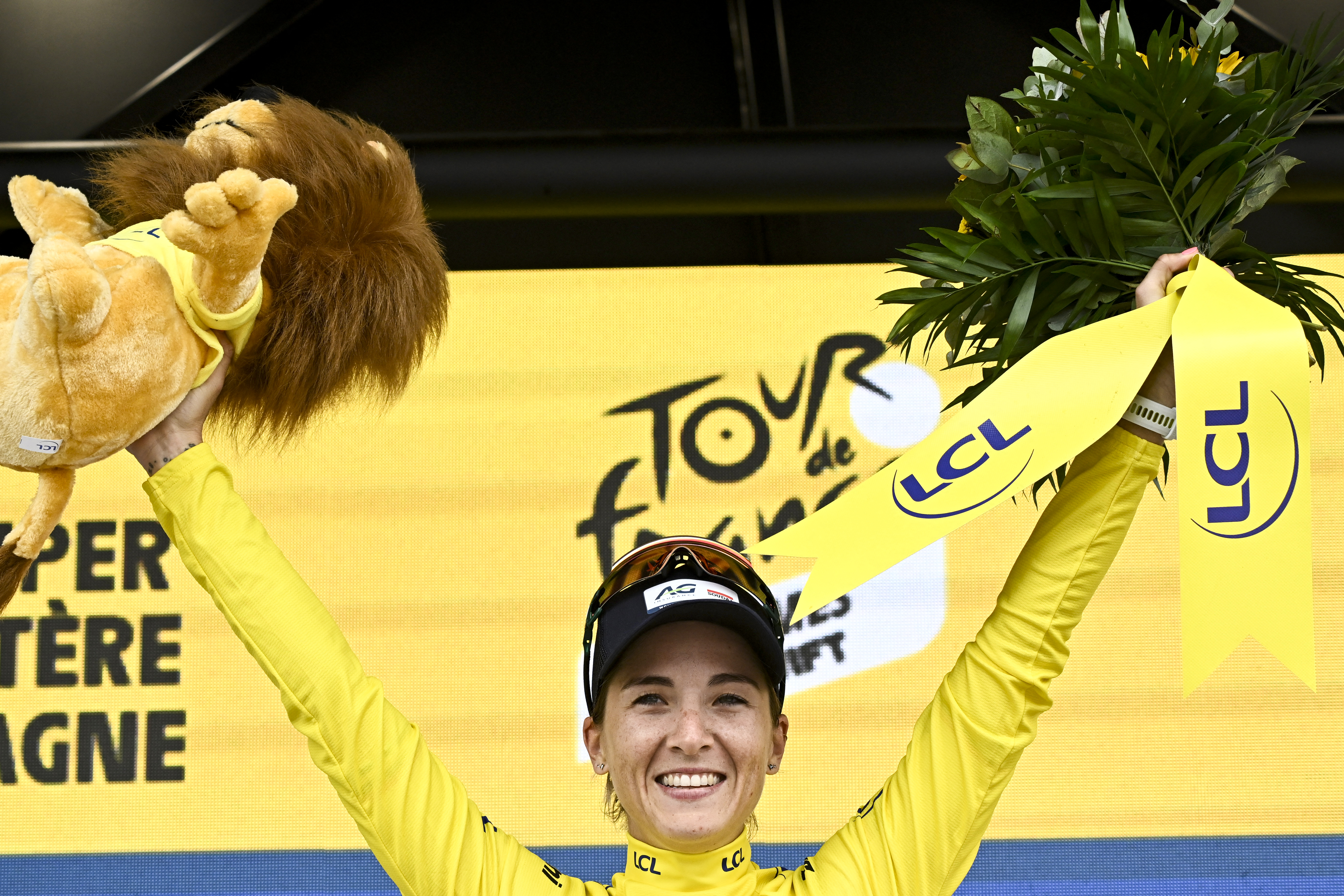 AG Insurance - Soudal Team's Mauritius rider Kimberley Le Court Pienaar celebrates on the podium with the overall leader's yellow jersey after the 2nd stage (out of 9) of the fourth edition of the Women's Tour de France cycling race, 110,4 km from Brest to Quimper