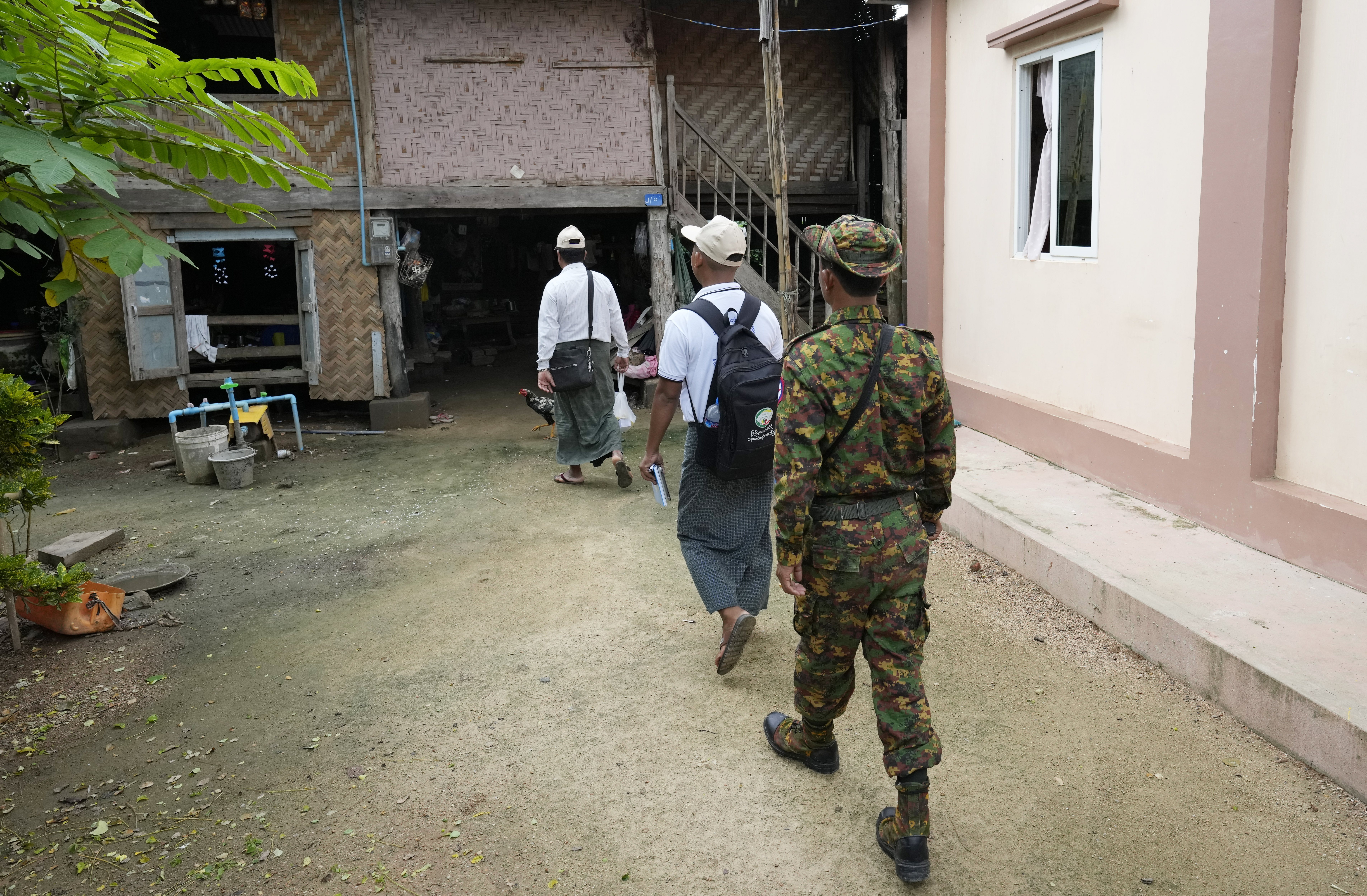 A soldier provides security to census enumerators.