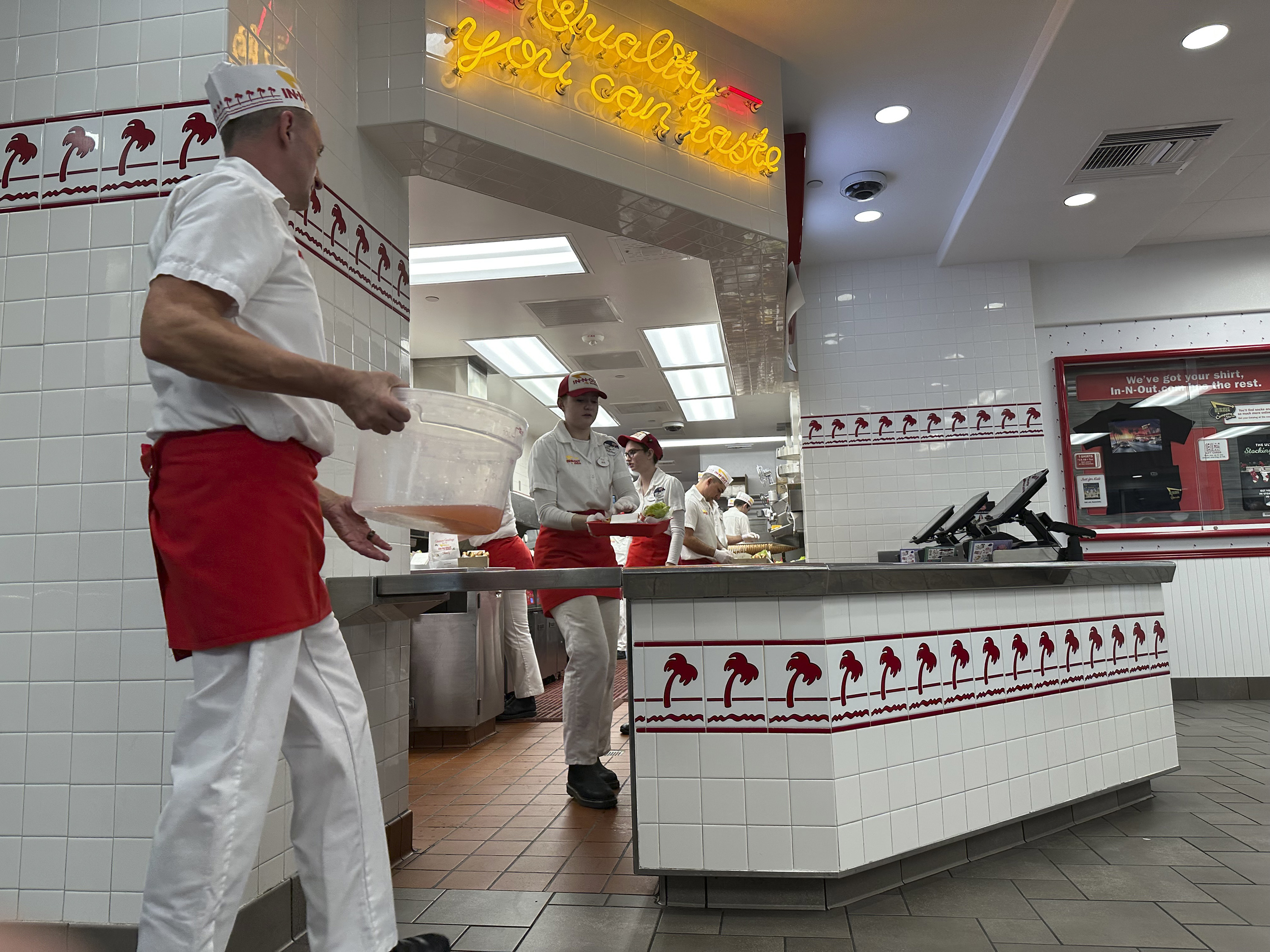 Workers toil in an In-N-Out Burger restaurant Sunday, Dec. 8, 2024, in Lone Tree, Colo. (AP Photo/David Zalubowski)