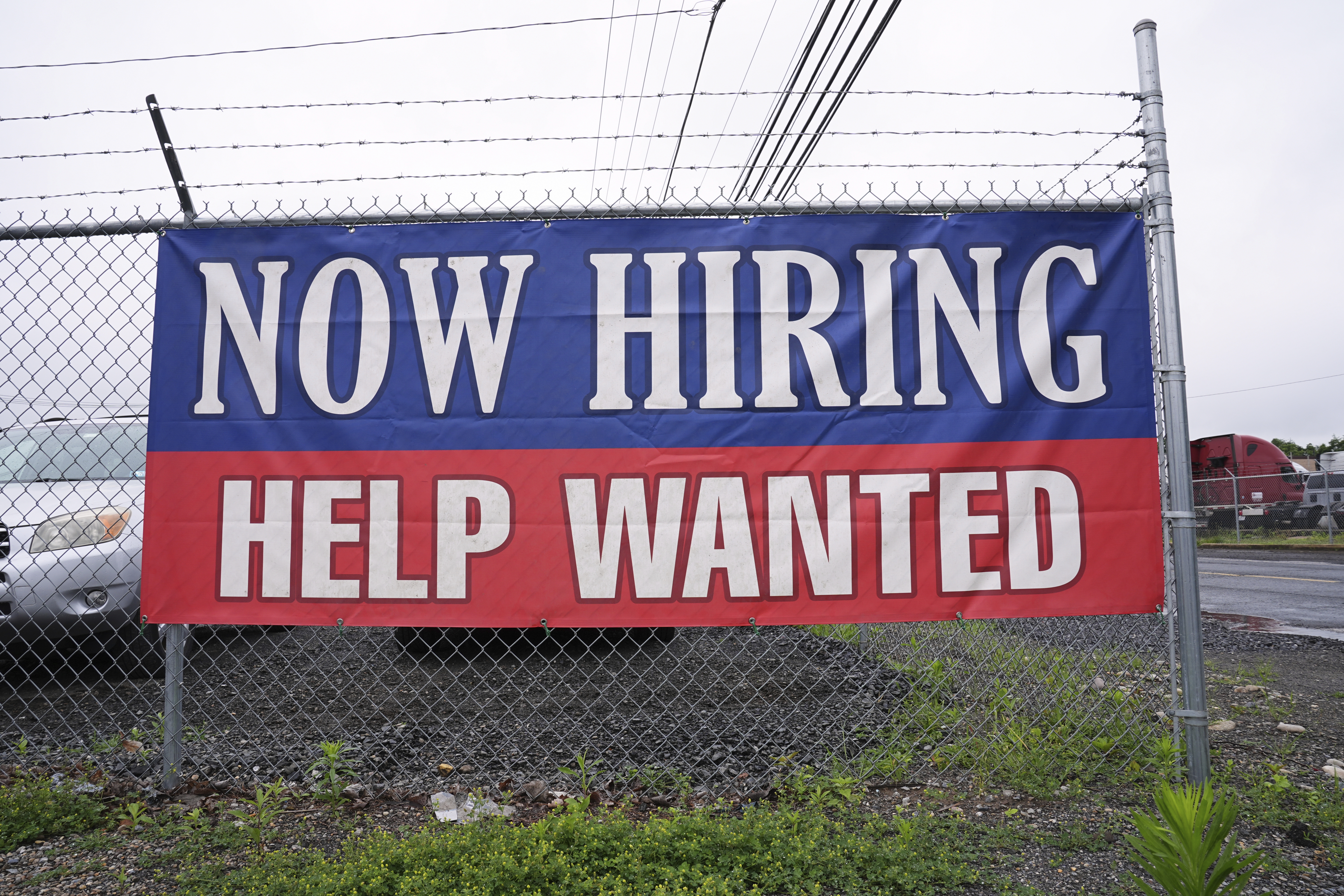 A now hiring and help wanted sign is posted in Morrisville, Pa., Monday, June 9, 2025. (AP Photo/Matt Rourke)