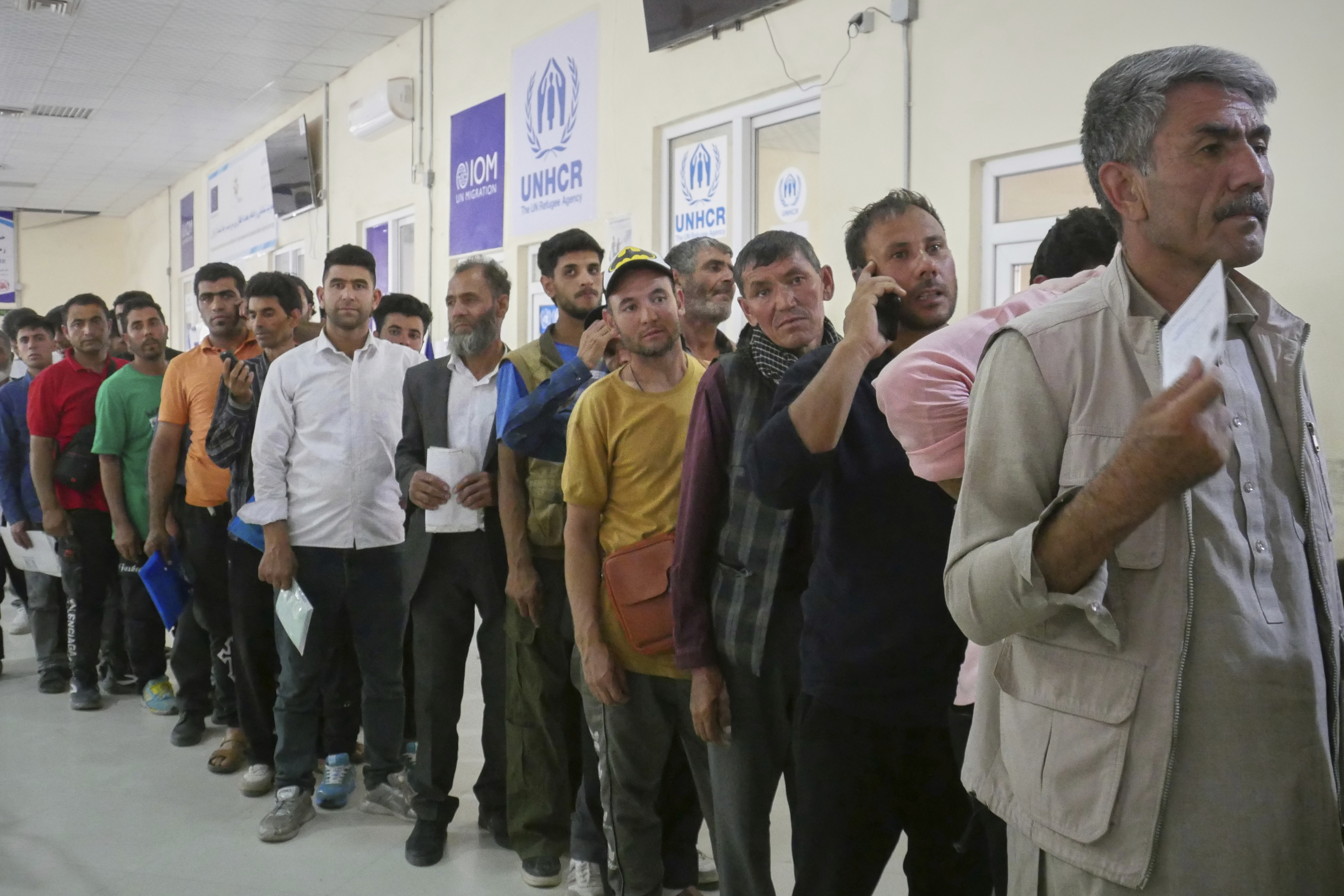 people stand in line next to signs that read ohchr