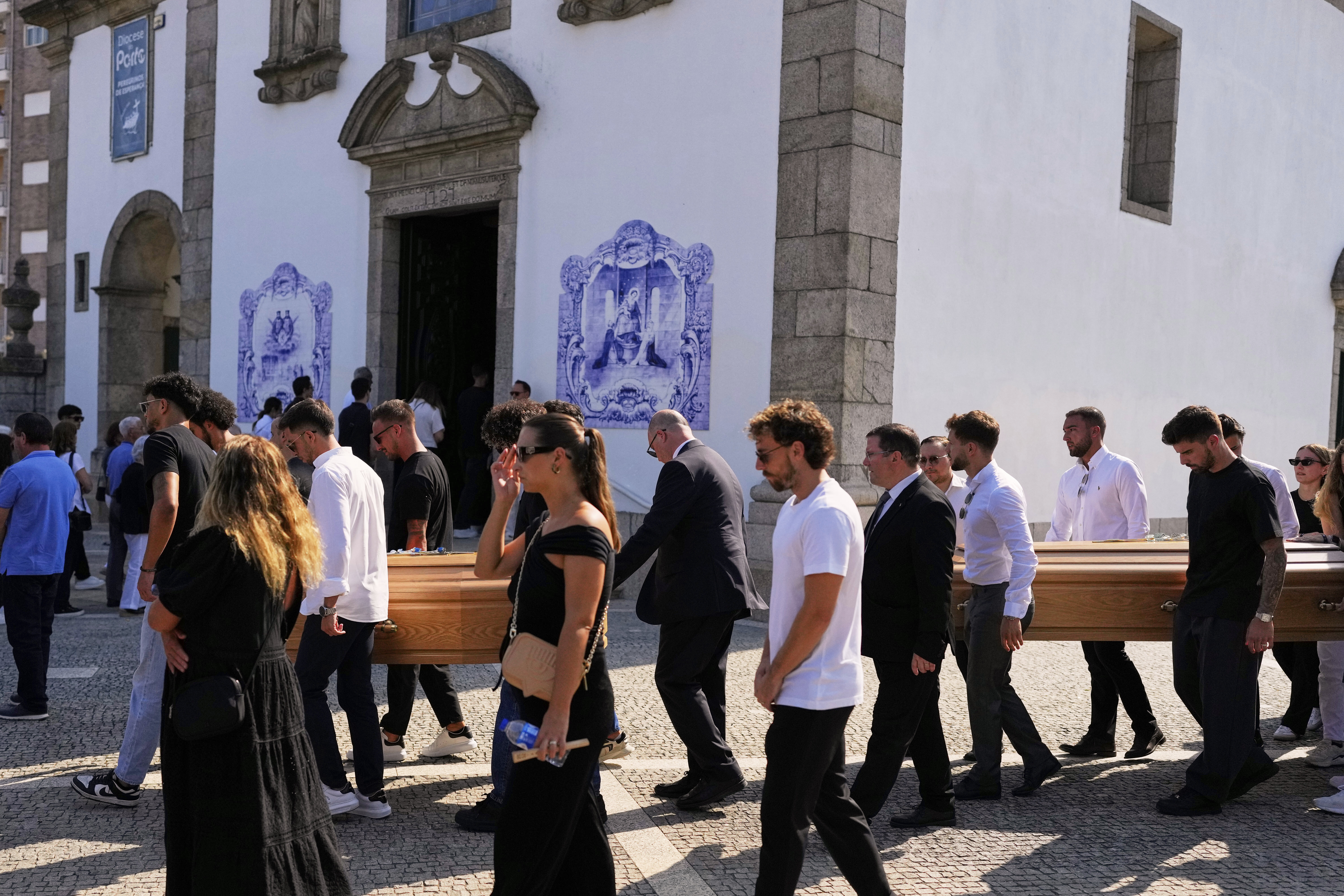 The coffins of Diogo Jota and his brother André Silva are carried outside the church during their funeral
