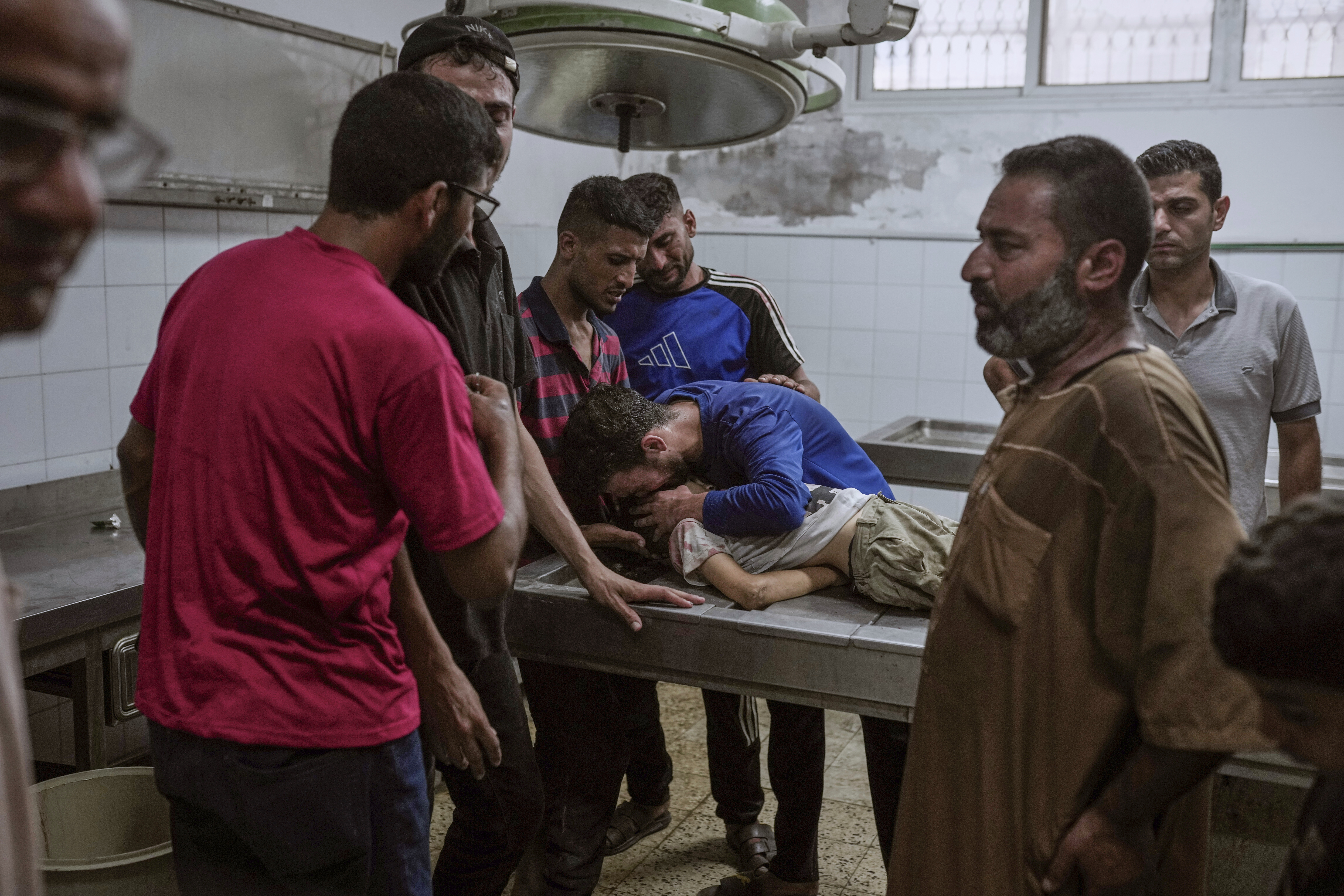 Palestinians mourn a child killed in an Israeli military airstrike on Gaza, at the morgue of Shifa Hospital in Gaza City, Saturday, July 12, 2025. (AP Photo/Jehad Alshrafi)