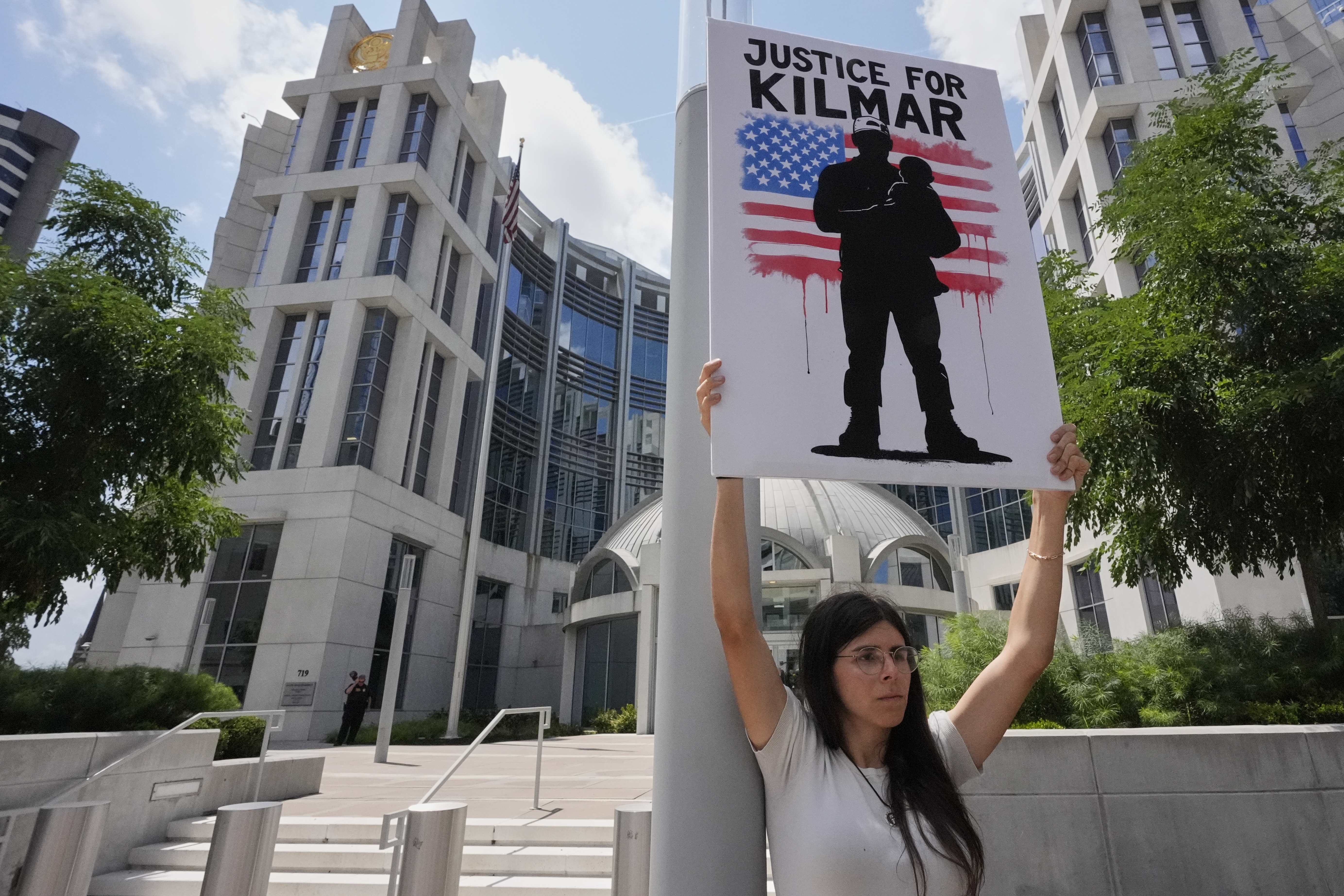a protester holds a sign in support of Kilmar Abrego Garcia