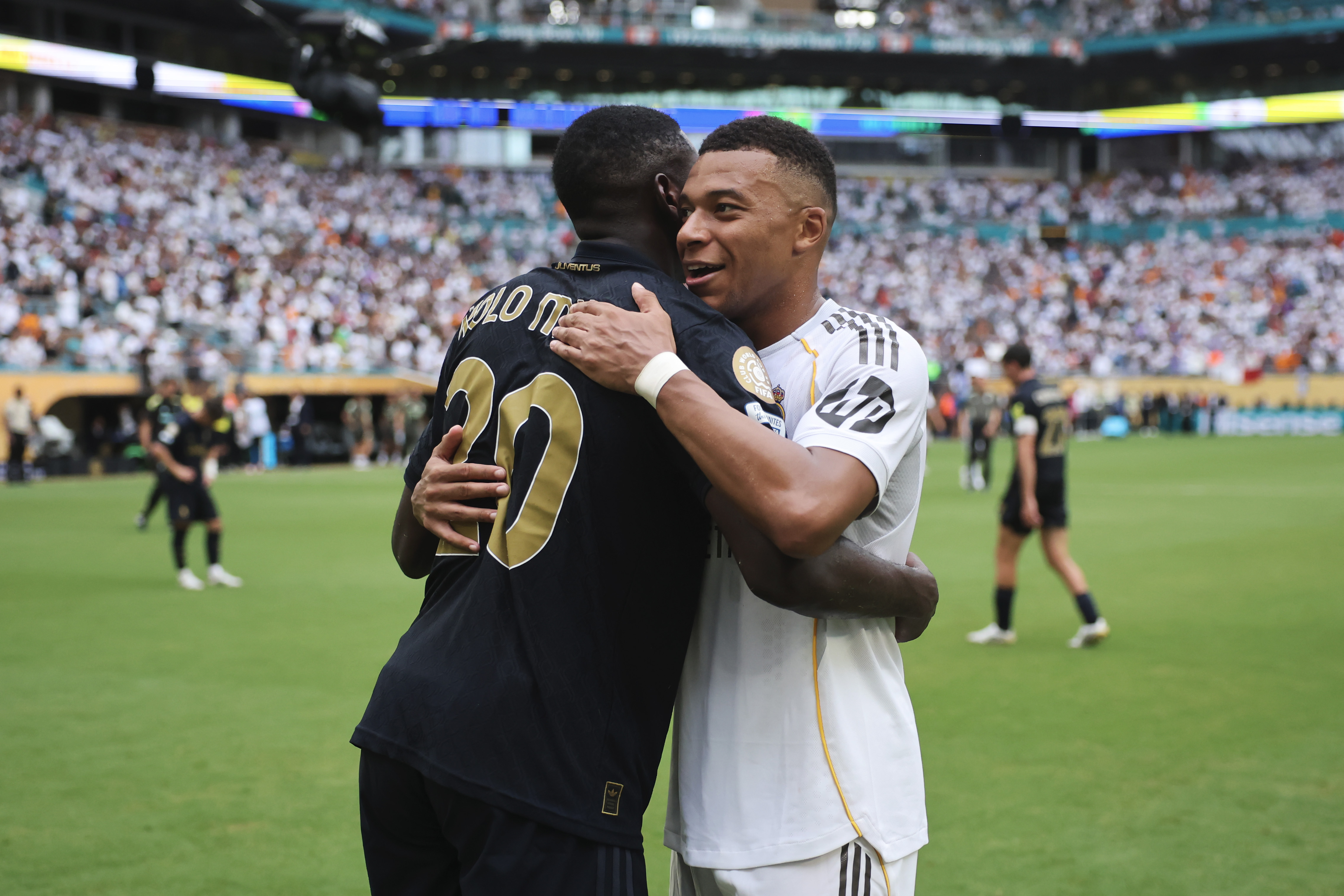 Kylian Mbappe of Real Madrid C.F. and Randal Kolo Muani of Juventus FC embrace during the FIFA Club World Cup 2025 round of 16 match