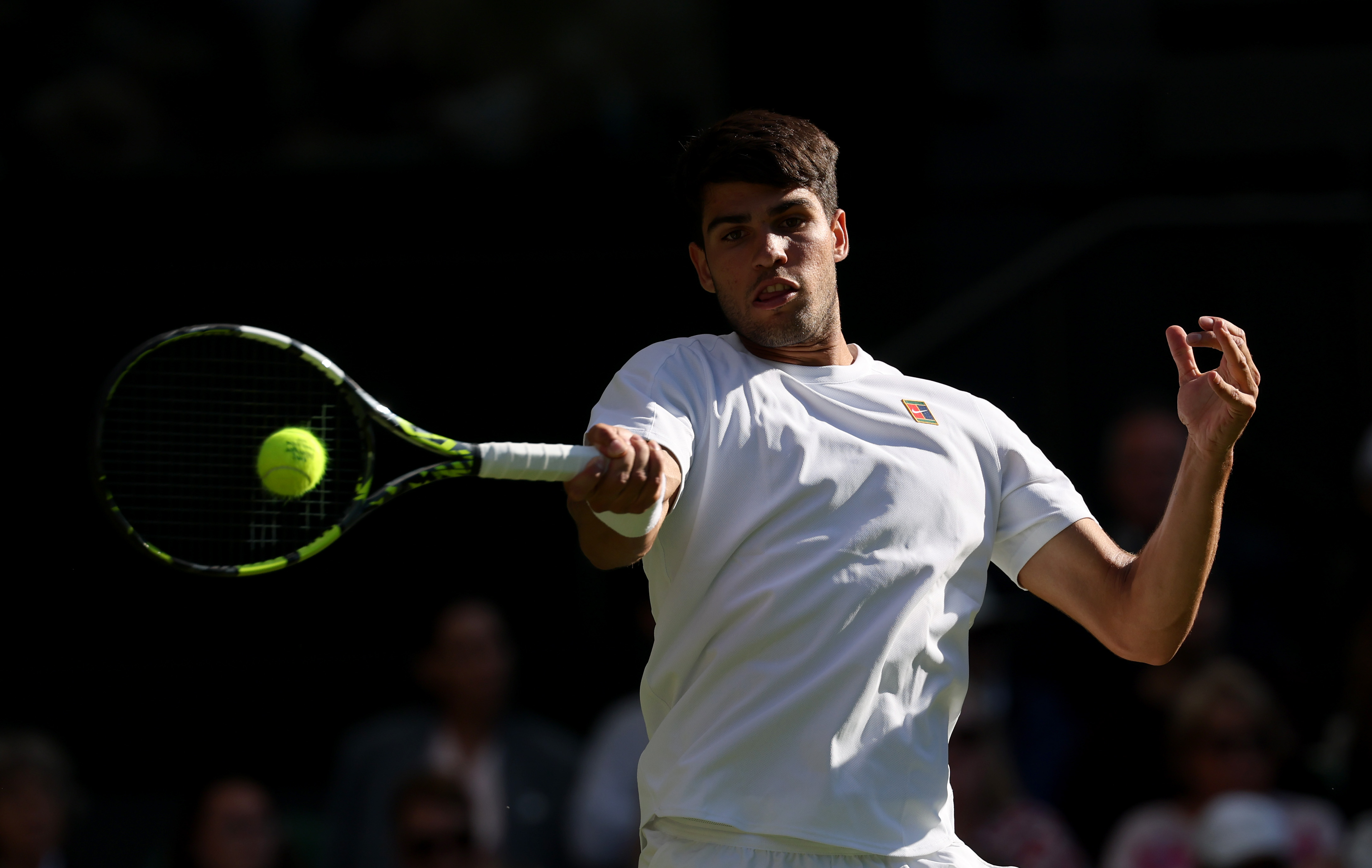 Carlos Alcaraz of Spain plays a forehand against Oliver Tarvet of Great Britain during the Gentleman's Singles Second Round match on day three of The Championships Wimbledon 2025
