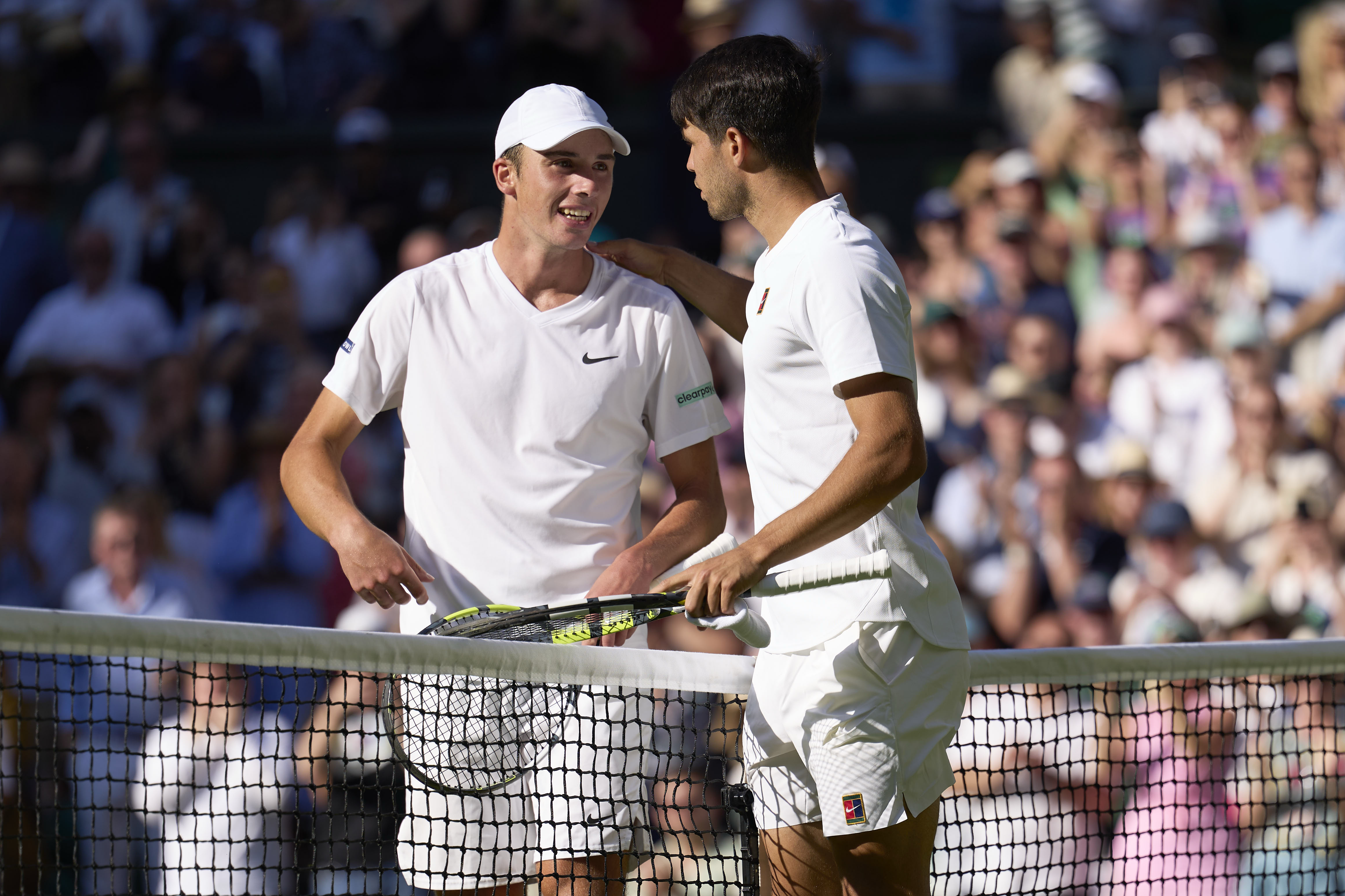 Oliver Target of Great Britain at the net with Carlos Alcaraz of Spain during the Gentlemen's Singles second round match on day three of The Championships Wimbledon 2025