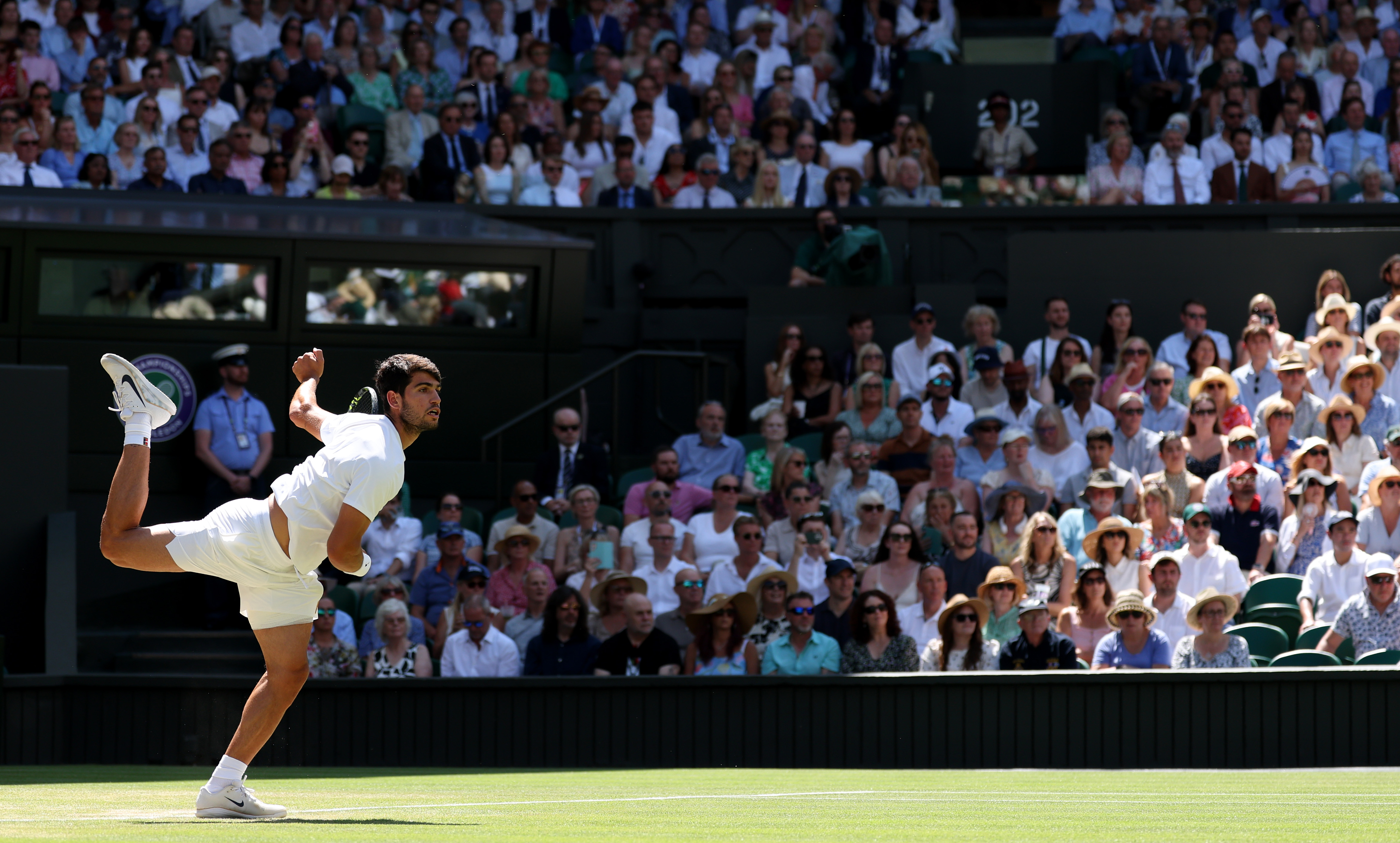Carlos Alcaraz of Spain serves against Taylor Fritz of United States during the Gentlemen's Singles semi-final match on day eleven of The Championships Wimbledon