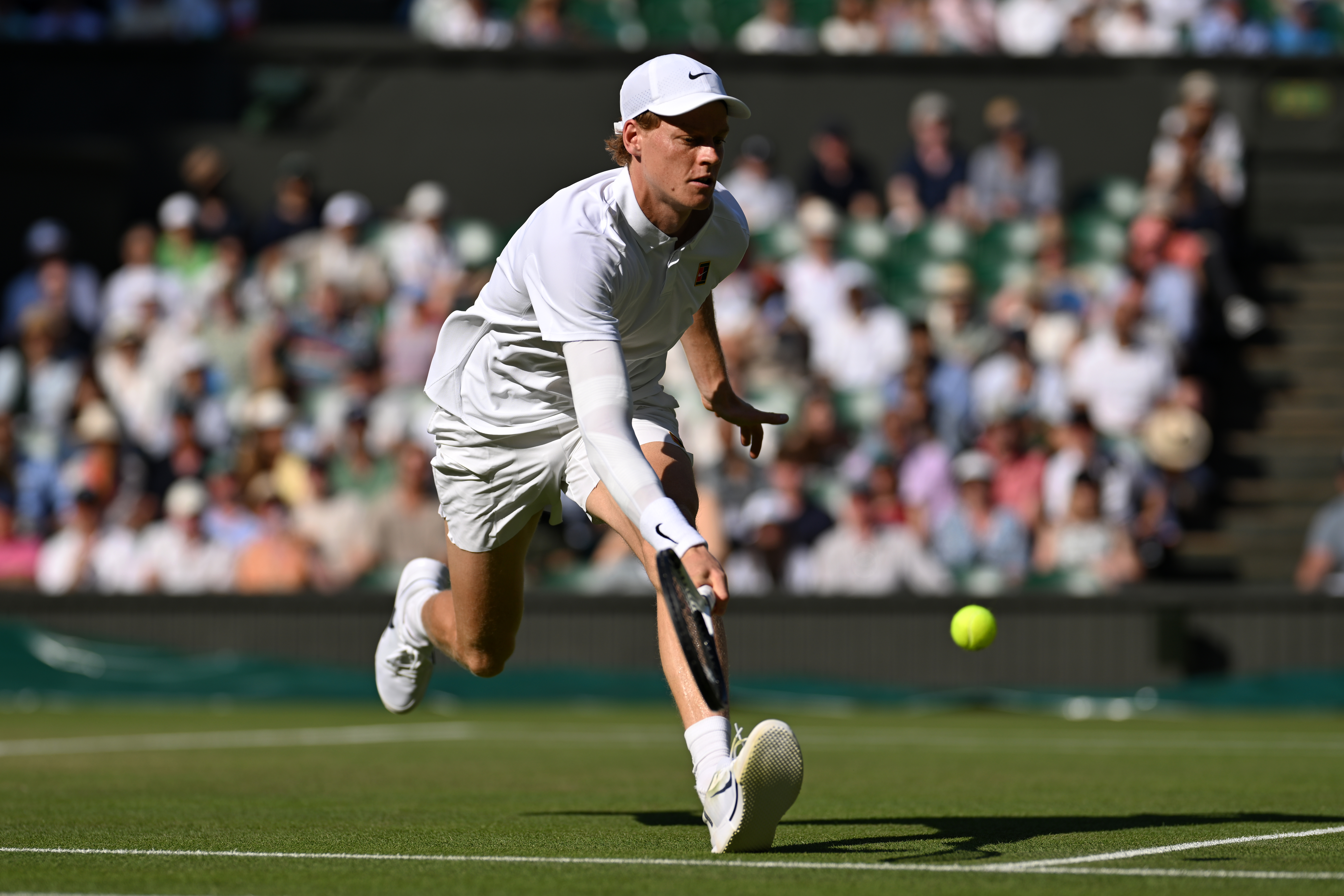 Jannik Sinner of Italy in action against Novak Djokovic of Serbia during the Gentlemen's semifinal