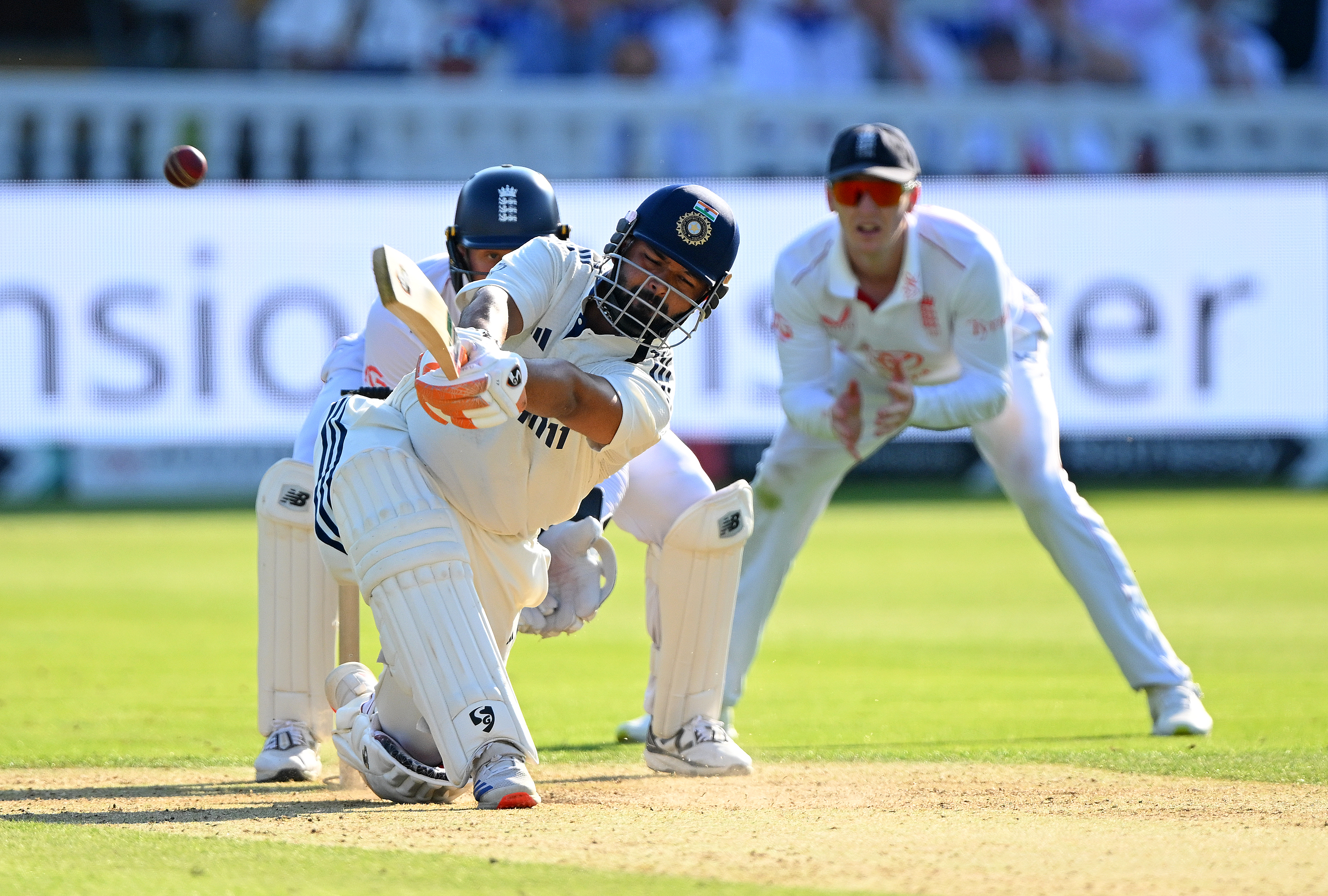 Rishabh Pant of India plays a shot for four runs as Jamie Smith of England looks on from behind the stumps during Day Two of the 3rd Rothesay Test Match between England and India at Lord's