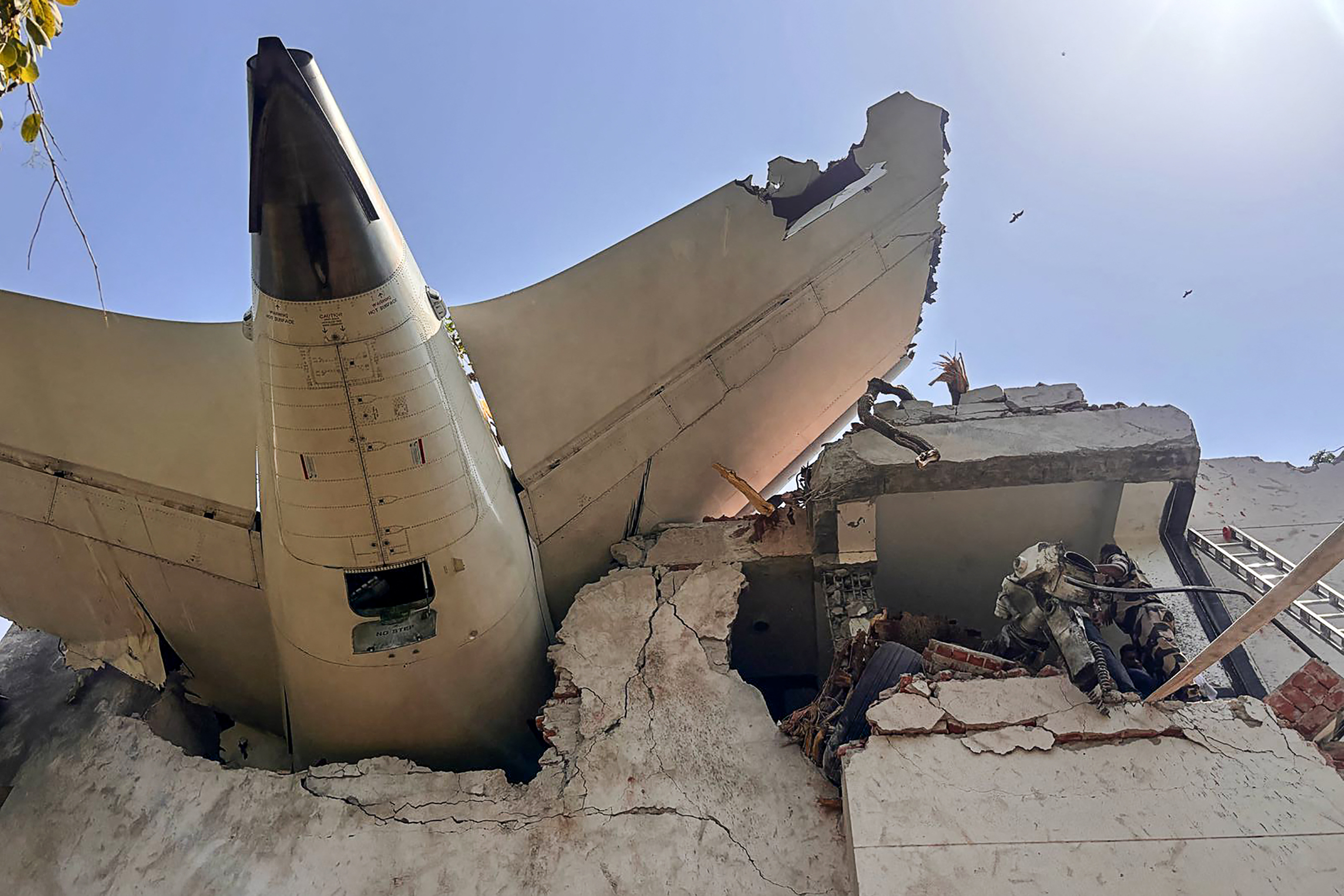 (FILES) This handout photograph taken and posted on the X (formerly Twitter) account of the Central Industrial Security Force (CISF) on June 12, 2025 shows the tailpiece of Air India flight AI171 after it crashed in a residential area near the airport in Ahmedabad.