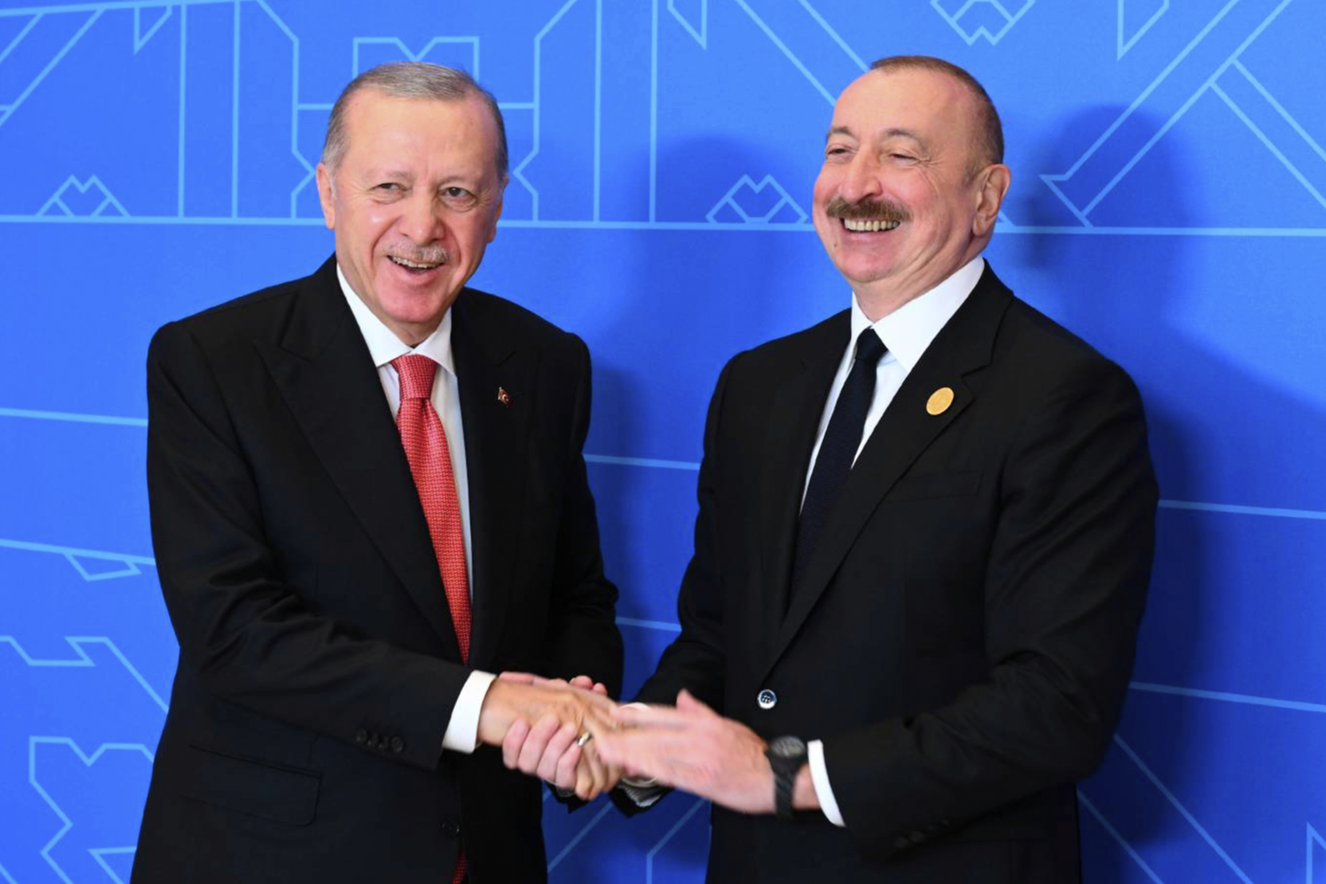 Azerbaijani President Ilham Aliyev, right, and Turkish President Recep Tayyip Erdogan pose for a photo.