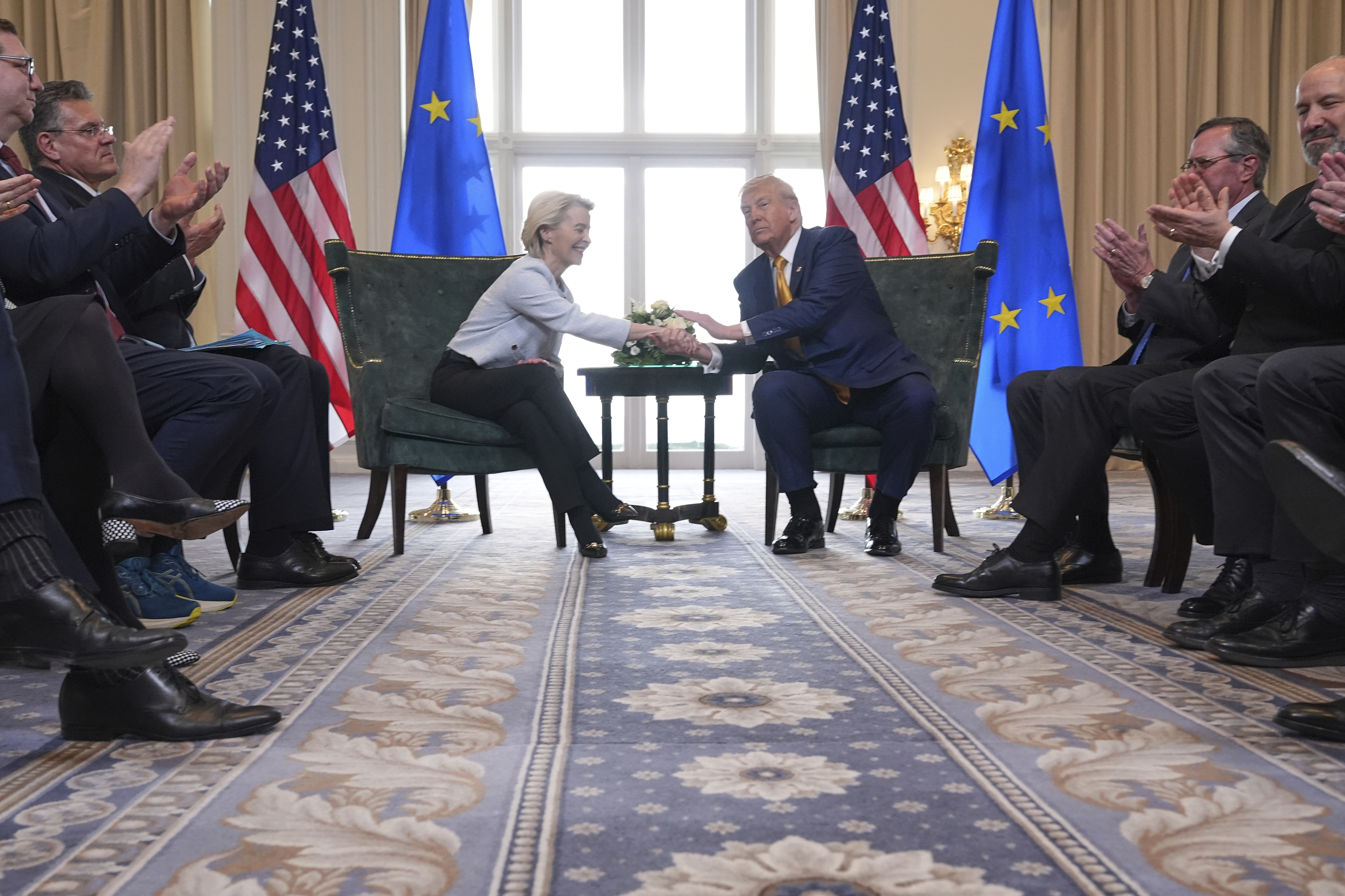 President Donald Trump and European Commission President Ursula von der Leyen shake hands.