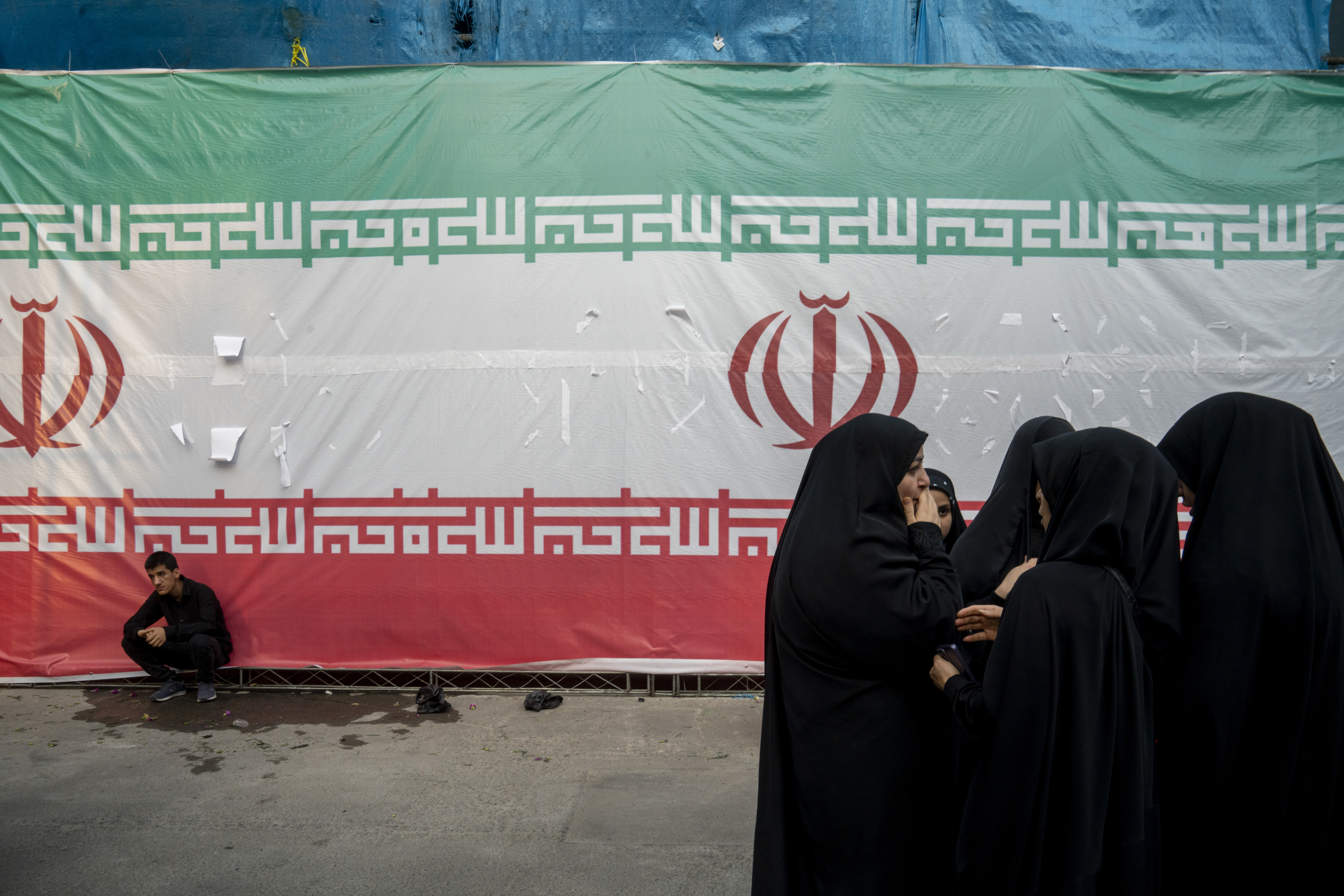 Iranians gather outside a building targeted in the Israeli attacks.