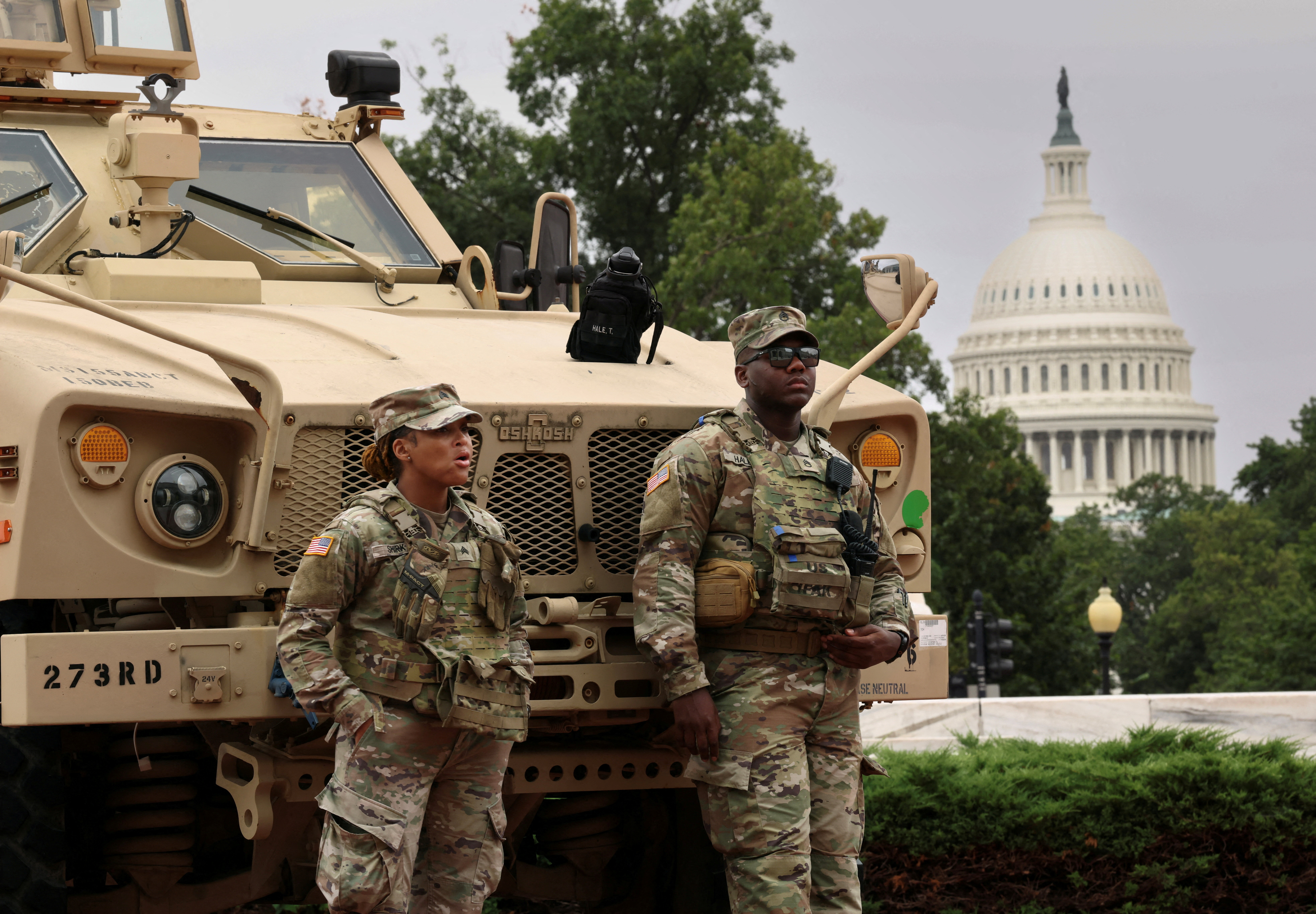 Two soldier in front of armoured vehicle