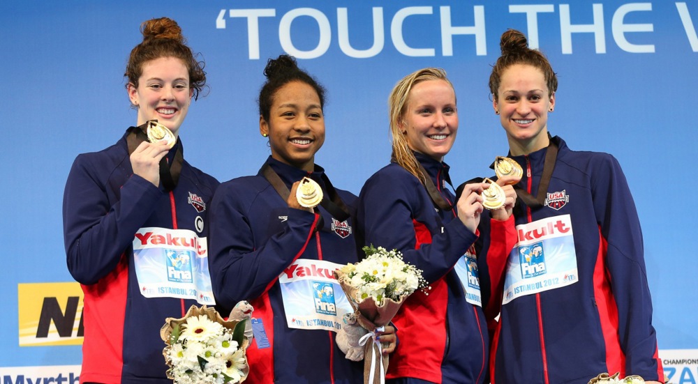 Members of the US relay team (L-R) Allison Schmitt, Lia Neal, Jessica Hardy and Megan Romano pose with their gold medals on the podium after winning the women's 4x100m freestyle relay final during the Short Course Swimming World Championships