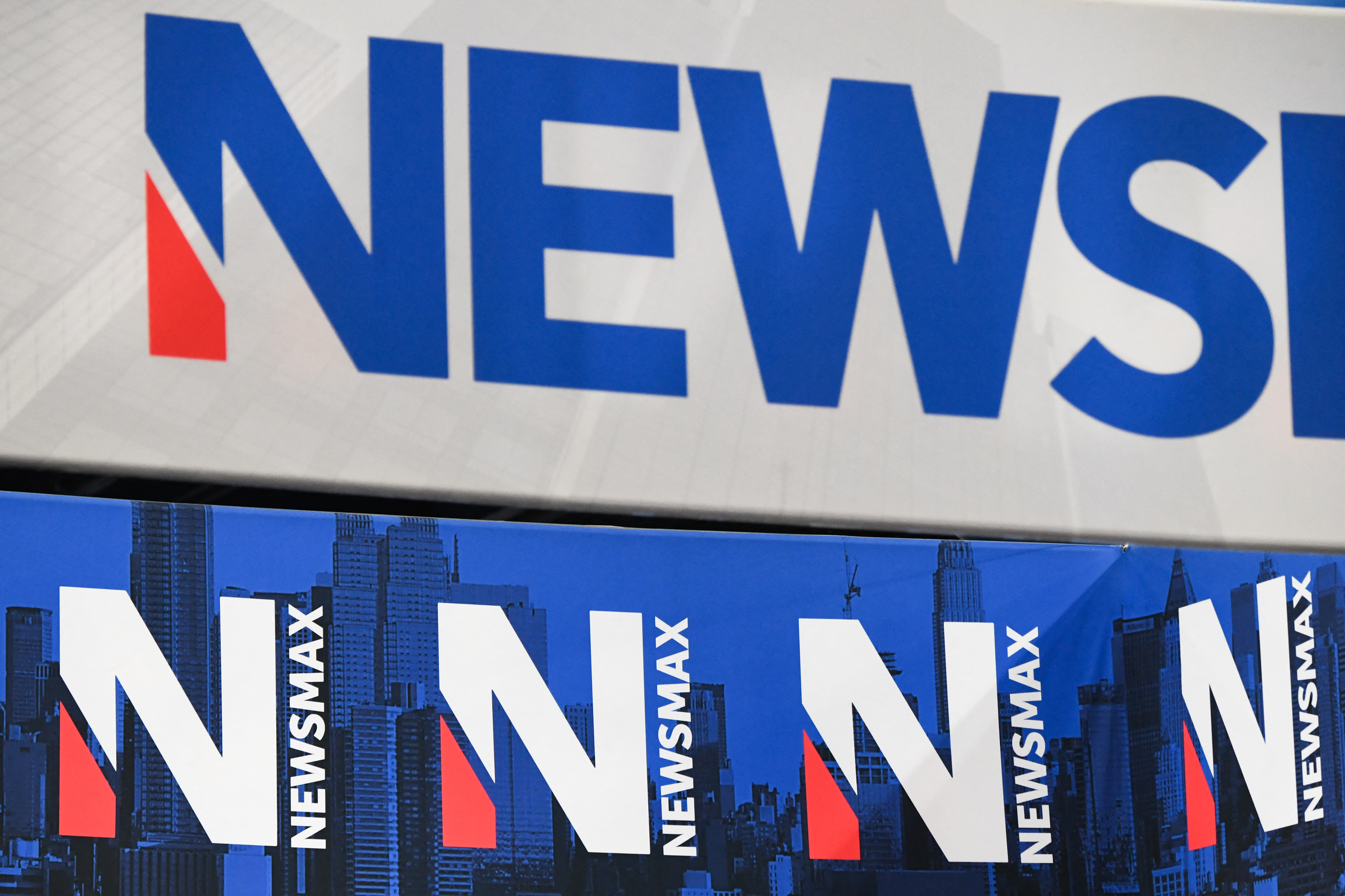 Signage for Newsmax is displayed at a broadcast TV booth at the annual meeting of the National Rifle Association (NRA) in Houston, Texas on May 28, 2022.