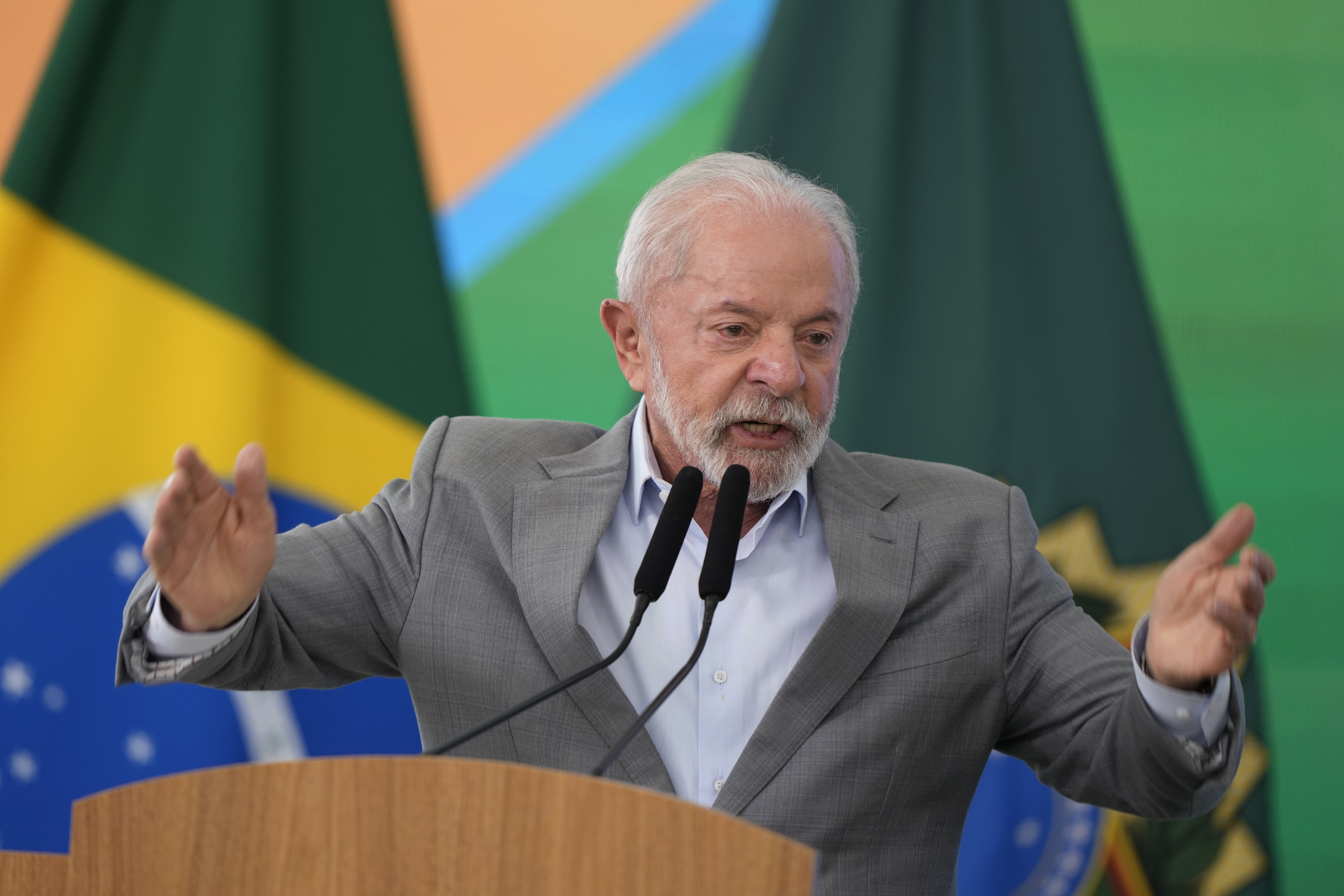 Luiz Inacio Lula da Silva speaks at a podium, his hands raised in gesture
