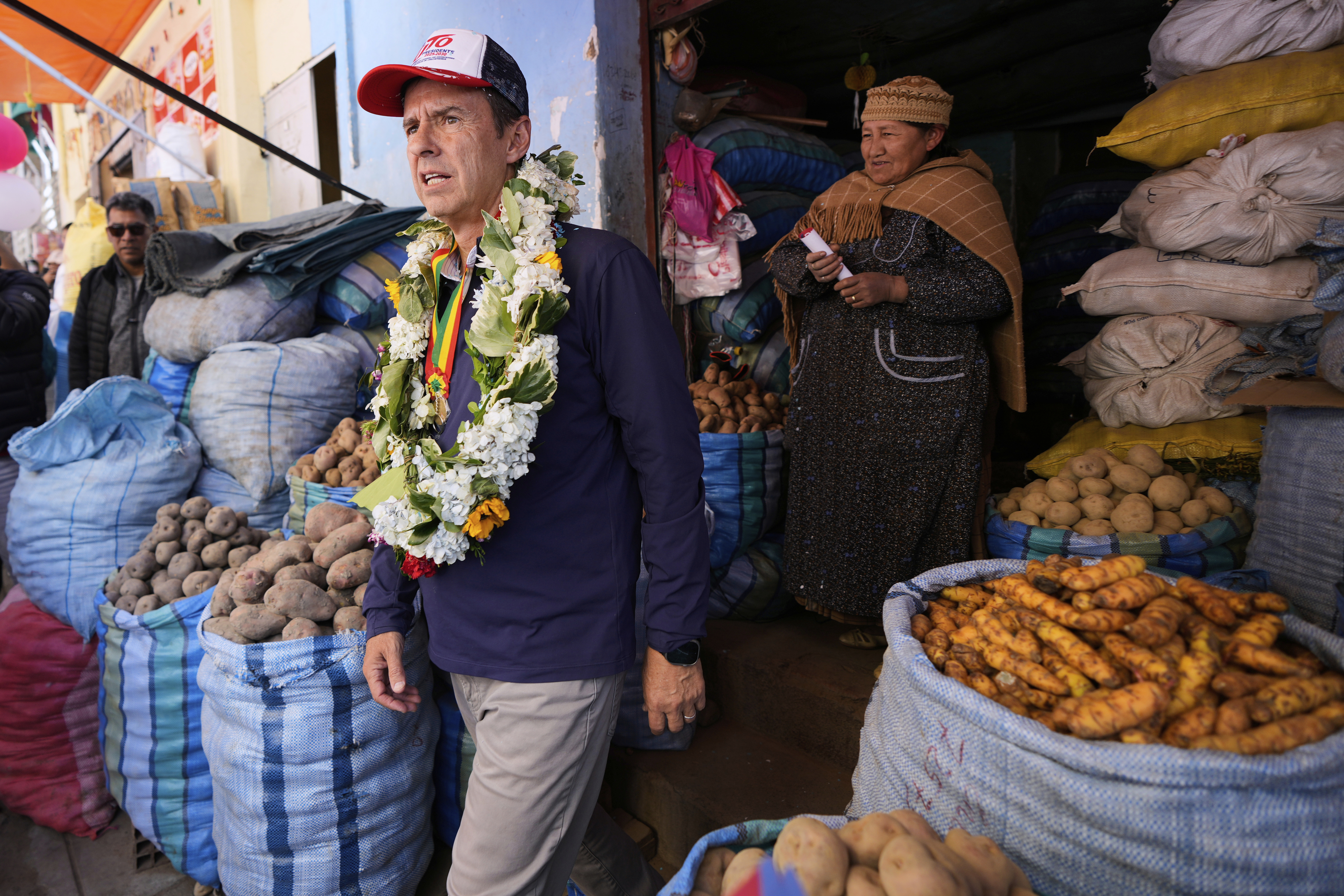 Jorge Quiroga steps out of a store selling root vegetables
