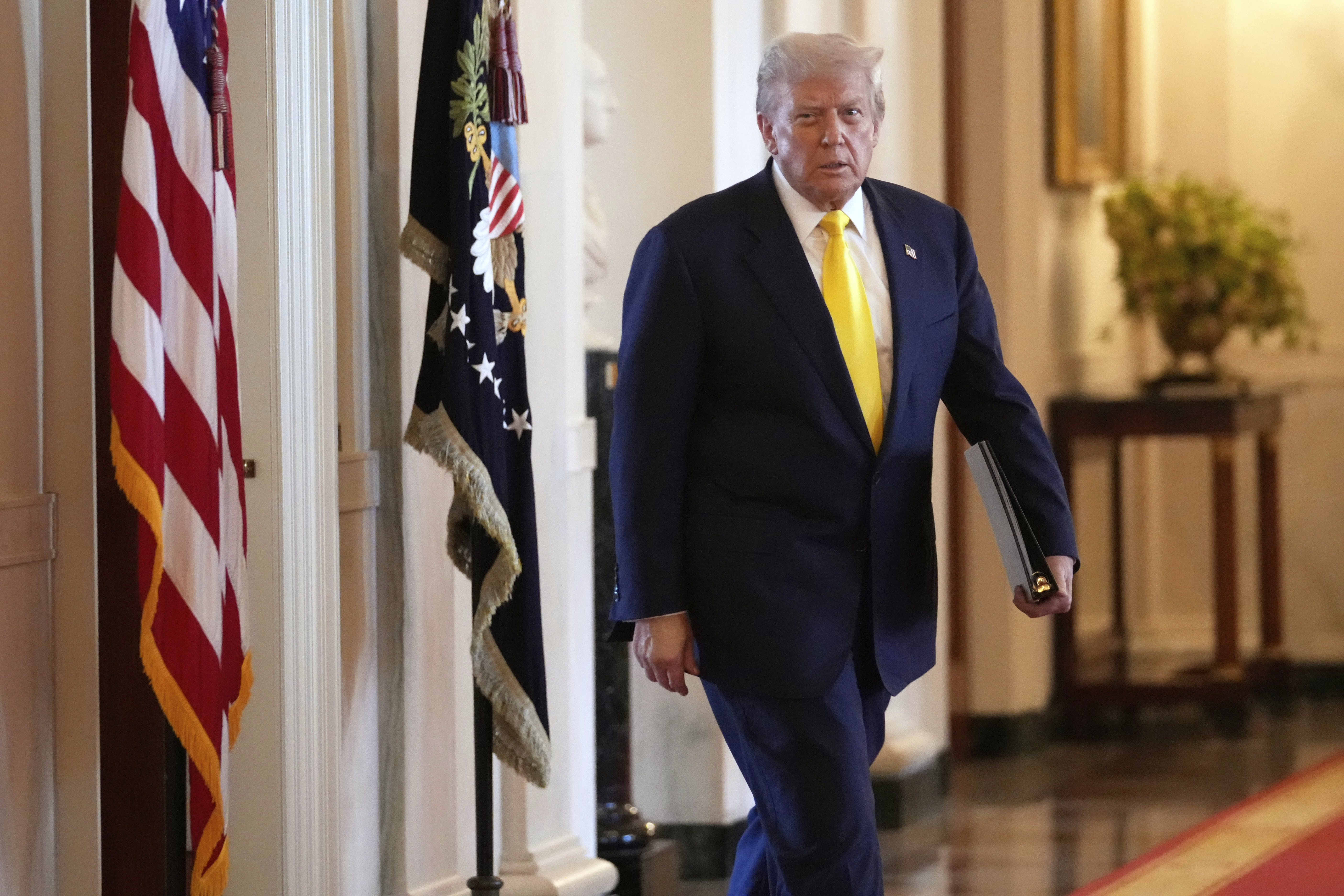 US President Donald Trump walks to speak at an event to mark National Purple Heart Day in the East Room of the White House, Washington on August 7, 2025.